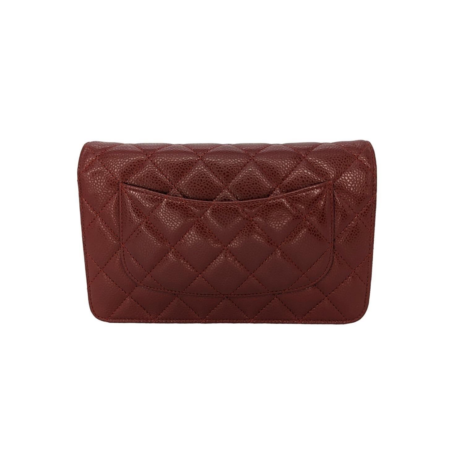 This is a chic wallet that is crafted beautifully of luxurious diamond quilted caviar leather in dark red. The wallet features a leather threaded silver chain crossbody shoulder strap, and a front flap with a small silver CC logo. This opens to an
