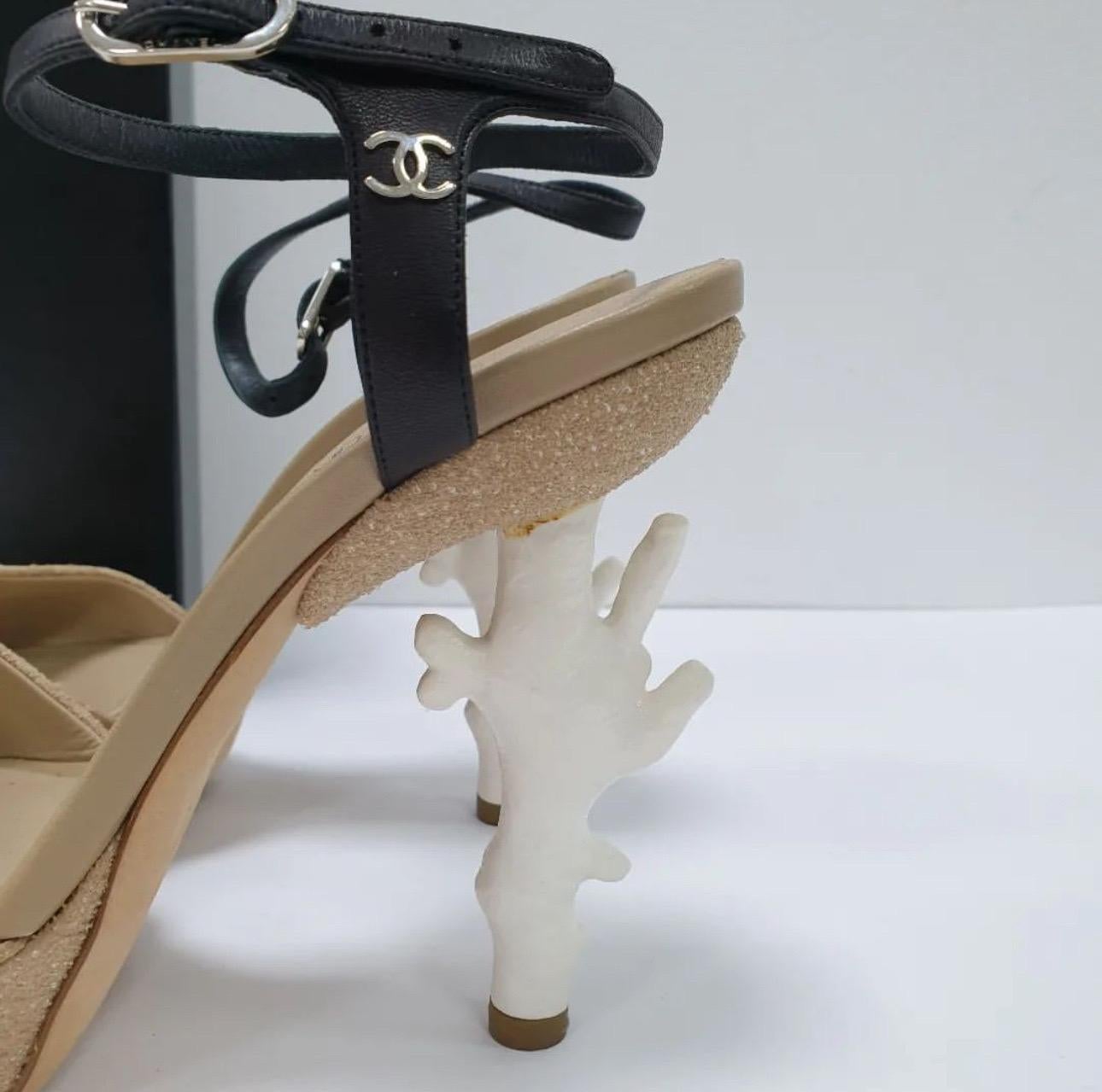 Authentic Chanel fantasy beige “sand” textured platform heeled sandals with white coral branch heels and black leather ankle strap.
 Extremely rare from the 2012 Spring/Summer collection. 
Size 37 with a 1.25” platform and 5” total heel height.
Very
