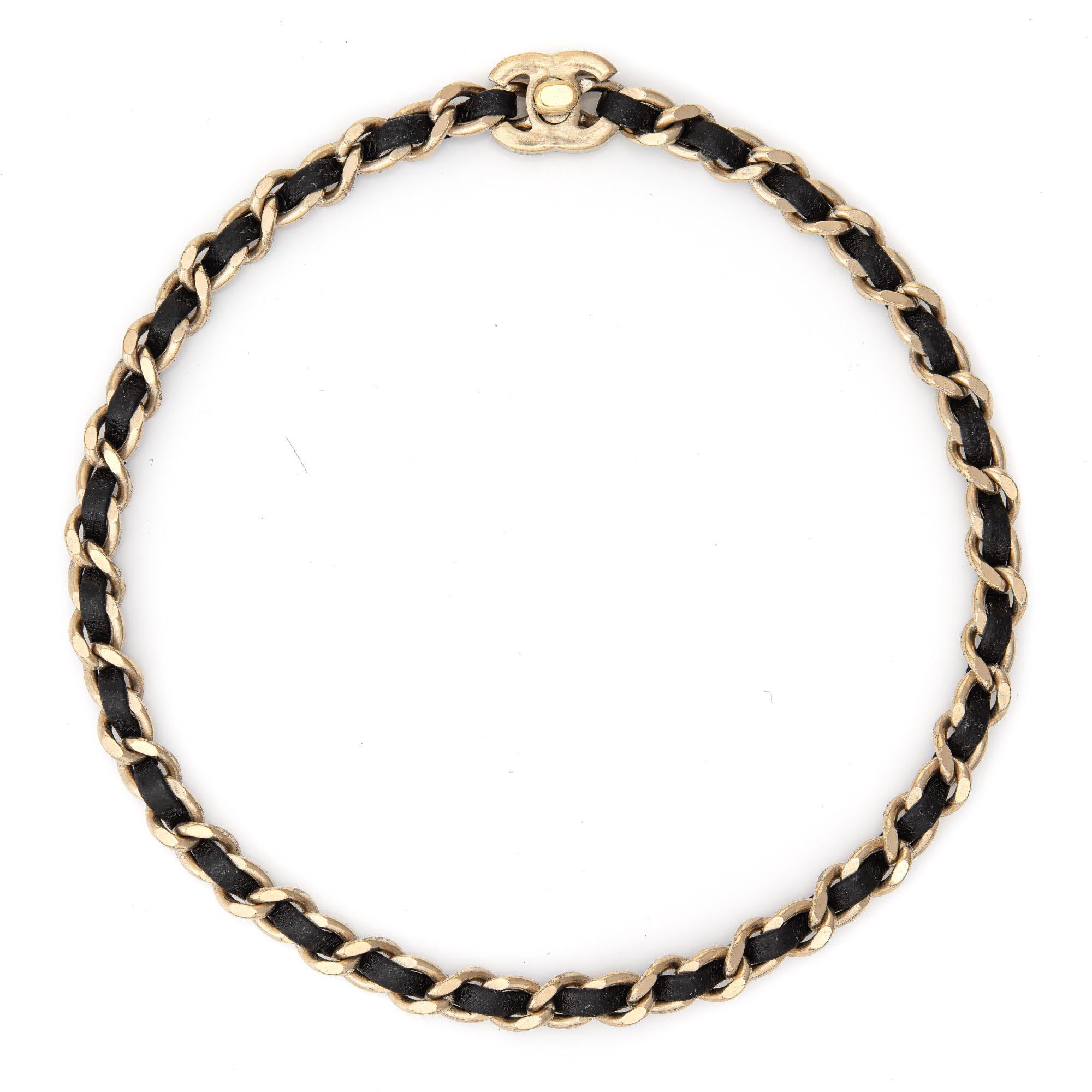 Pre-owned Chanel black leather chain link necklace crafted in yellow gold-tone (circa 2012) from the Spring collection. We also have available the matching silver-tone black leather chain link necklace. 

The black leather chain link necklace