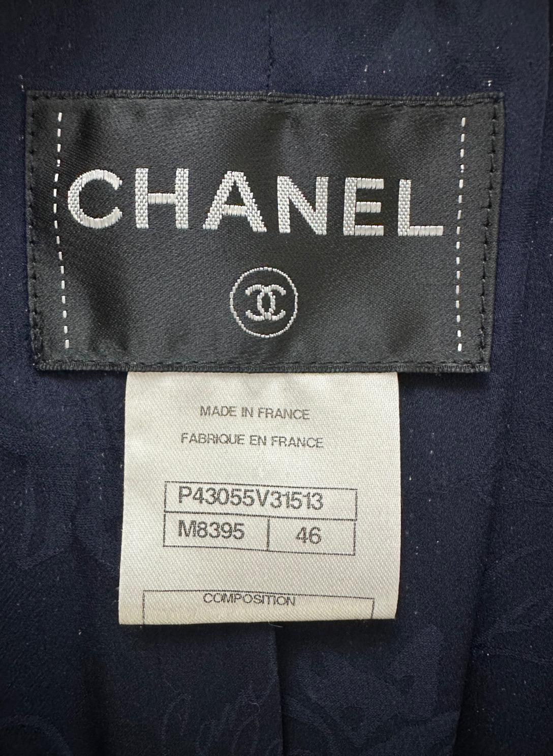 Timeless Chanel Navy Blue Tweed Jacket from the Spring 2012 Collection! 

Size 46. This stunning jacket features the iconic Chanel CC embroidered logo, a navy and black tweed pattern, and silver-tone 'seashell' buttons. It is similar to the one seen