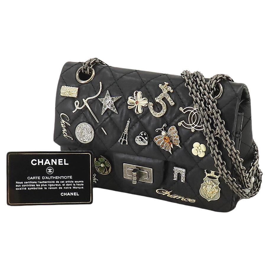 Quilted Chanel black lambskin charmed flap with mademoiselle closure and reissue chain

Year: 2012
Antique silver hardware
Interior flap zippered pocket
Interior flap
Interior open pockets
Interior engraved cc logo
Classic back pocket
8” W x 5” H x