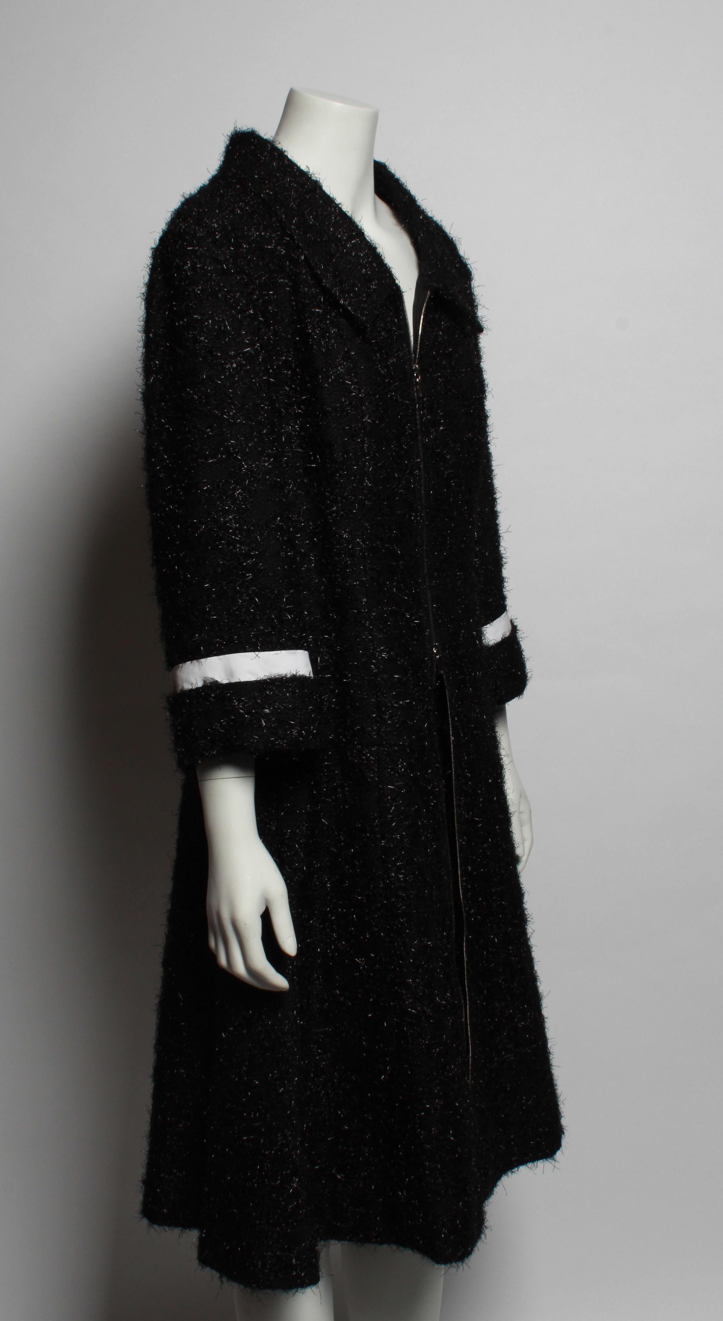 Stunning runway Chanel two piece coat and skirt suit ensemble from the 2013 Collection. 
Coat is made from luxurious black lurex boucle'  and features an A line silhouette, 2 way front zipper closure and detachable white cotton collar. The sleeve is