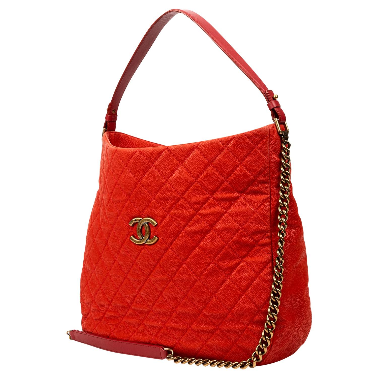 A rare vintage shopper from the Cruise 2013 Collection by the beloved Karl Lagerfeld. This practical and chic piece is crafted of vibrant yet elegant red caviar leather, gold-tone brass hardware, and a chain-link handle and single shoulder strap. We