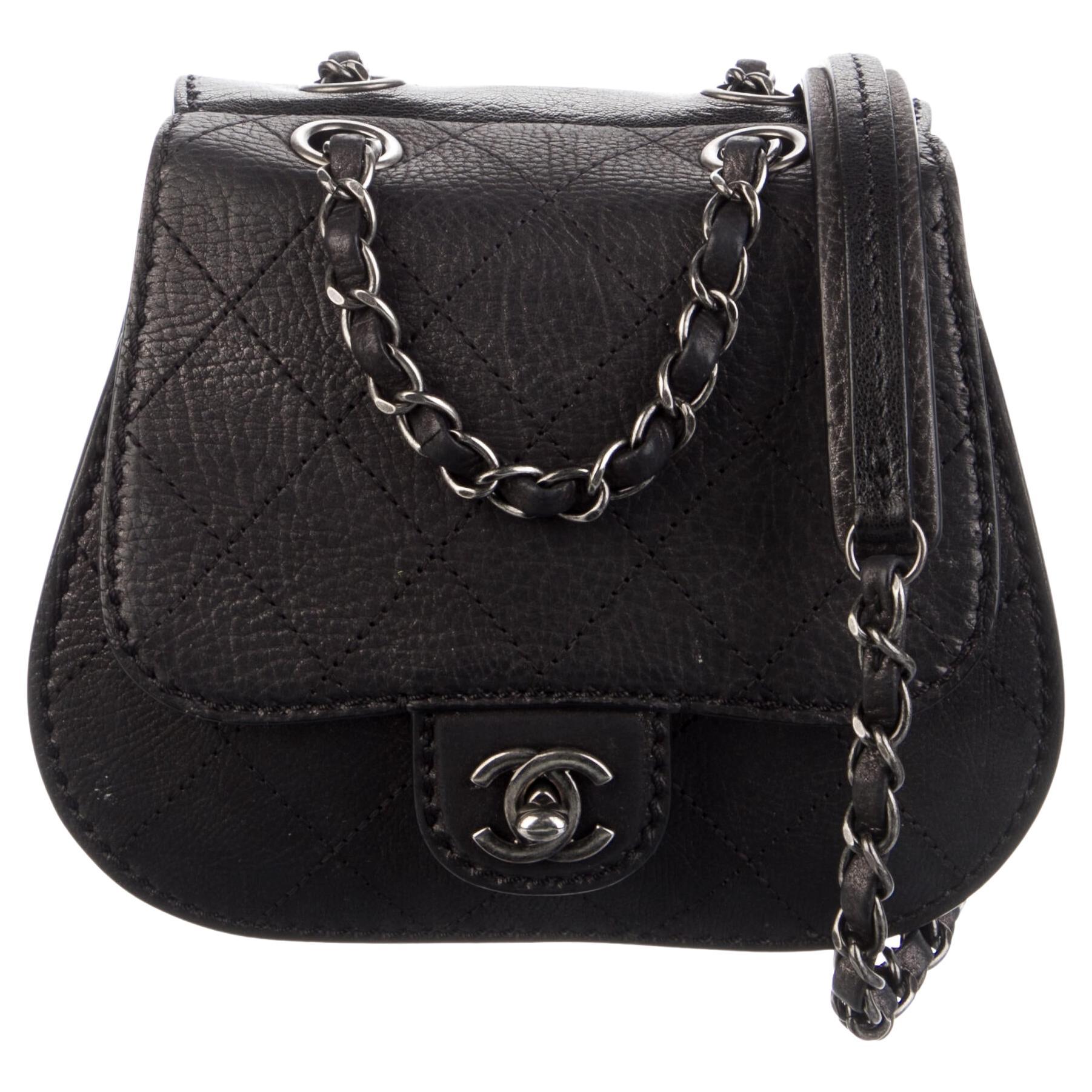 Chanel Classic Flap Small Mini Quilted Saddle Black Nubuck Leather Bag

Pre-Fall 2013
Diamond stitched nubuck leather
Ruthenium classic interwoven chain
Classic CC turn lock 
Satin-canvas interior lining
Main interior slide pocket
Rear exterior