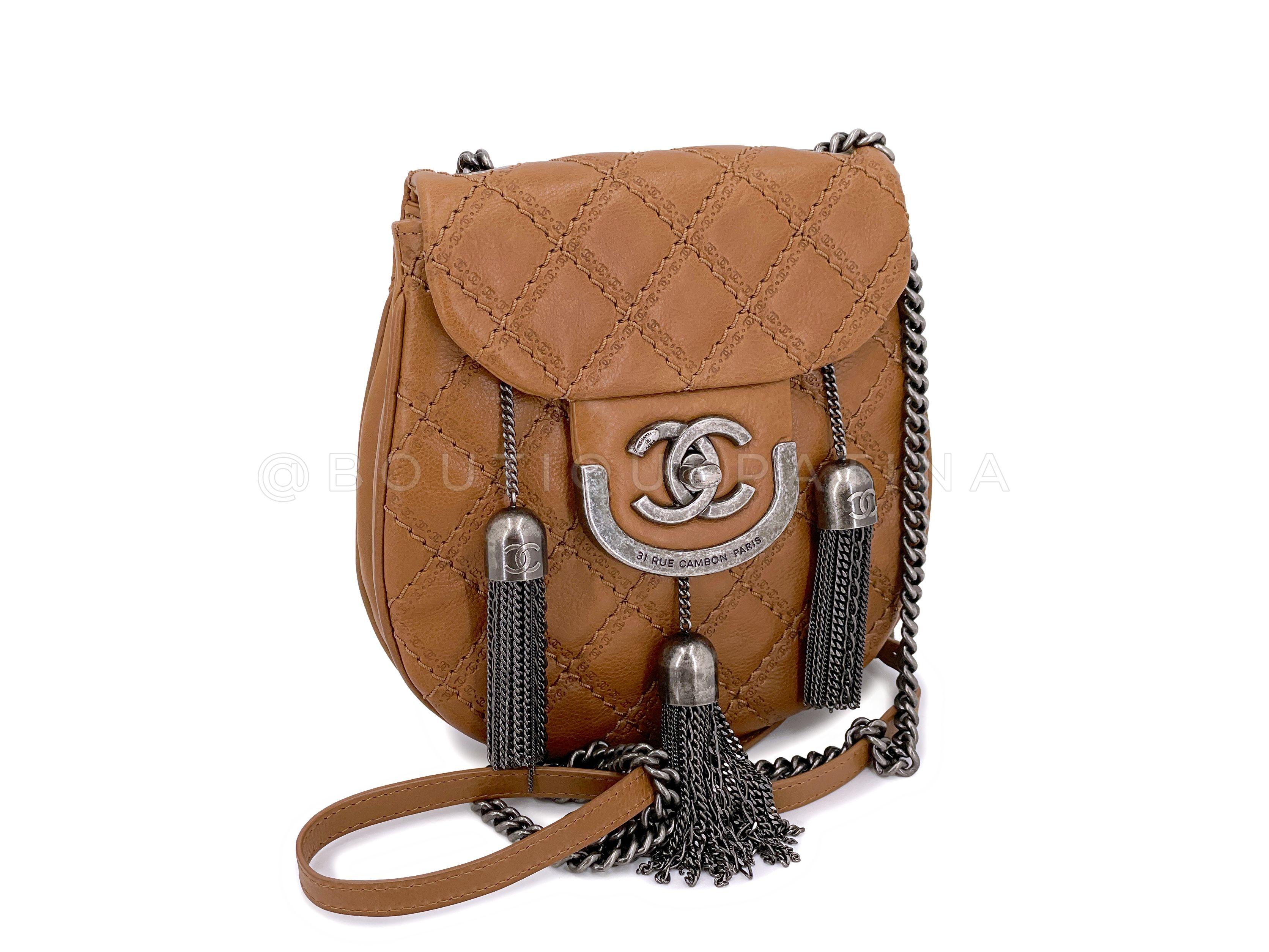 Store item: 66986
Limited production from the 2013 Chanel Paris-Edinburgh collection is this coco sporran flap bag. 

In the shape of a sporran pouch from Scotland with three tassels, this whimsical pouch has a long 24 inch crossbody chain in