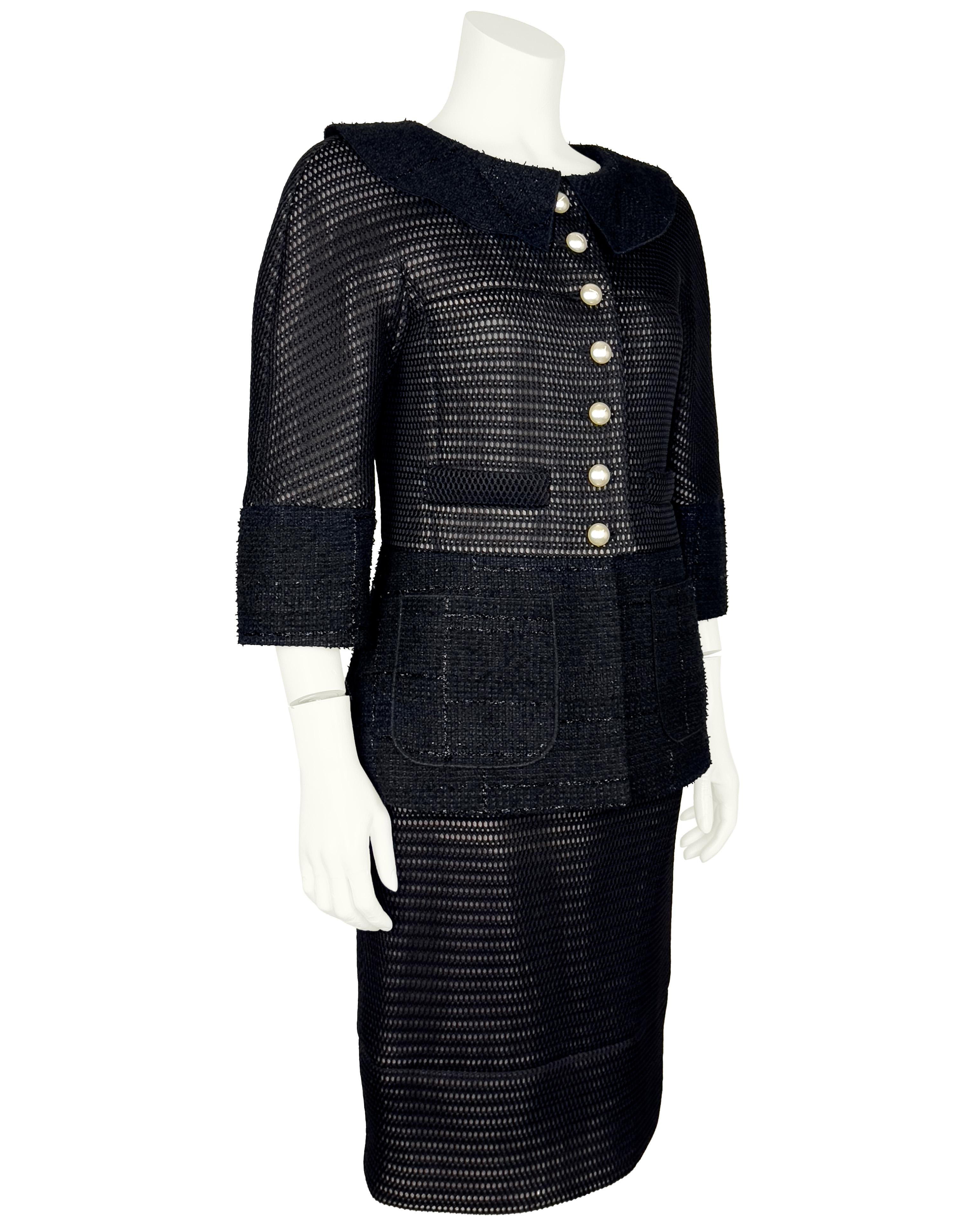 Chanel Spring 2013 RTW black mesh and tweed skirt suit with Peter Pan collar and pearl buttons. Fitted through the bodice with wool patch pockets and flared fit around the hips. Matching skirt in wool eyelet. Lined in nude and black silk. Excellent