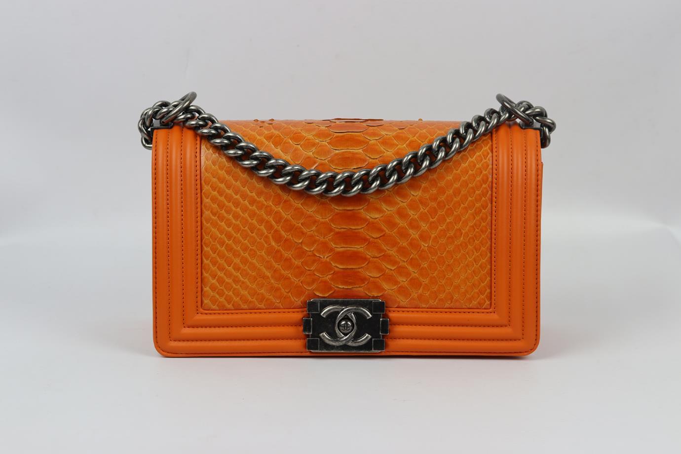 Chanel 2014 Boy medium python and leather shoulder bag. Made from orange python and leather with matching leather interior and antiqued gold-tone hardware and chain shoulder straps. Orange. Push lock fastening at front. Comes with authenticity card
