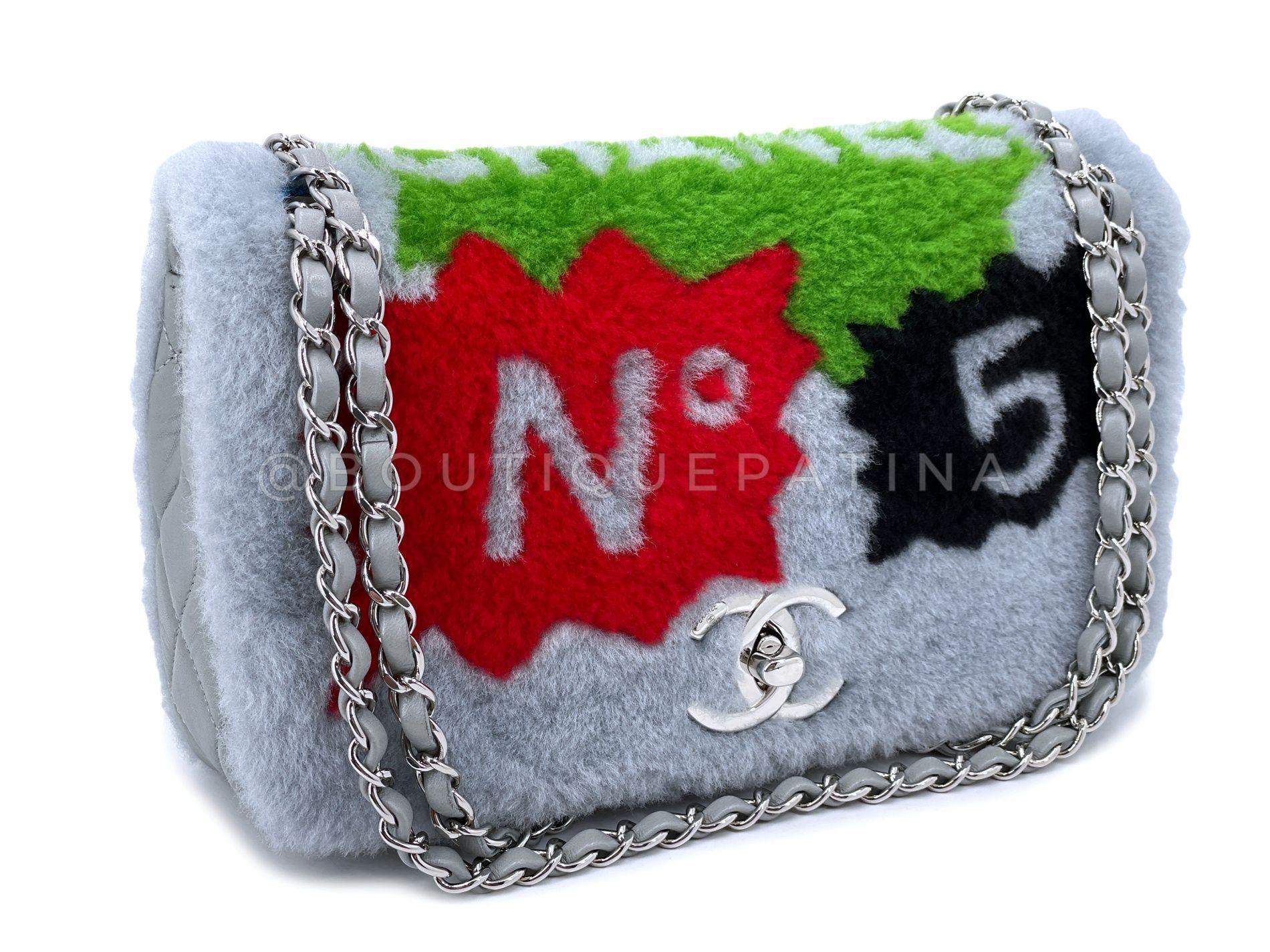Store item: 68183
This is a rare collector's item - Chanel 2014 Gray Supermarket Comic Multicolor Shearling Flap Bag SHW with quilted gray lambskin side and bottom panel, front and back shearling with comic print and gray leather interior.

As seen