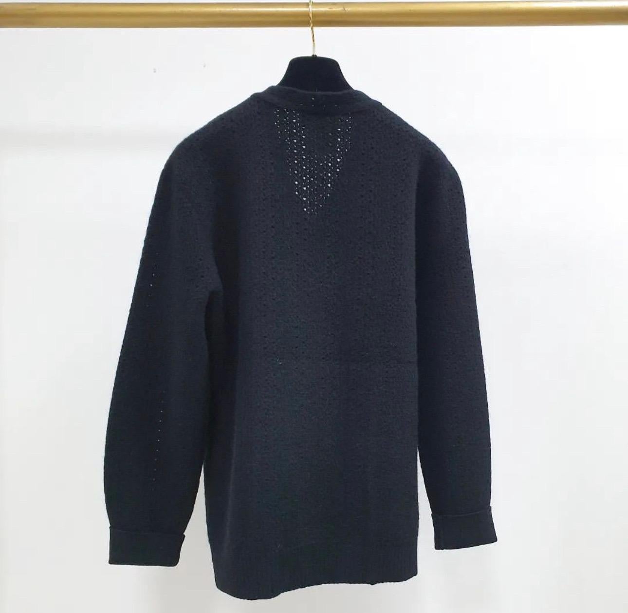 CHANEL 2014 Wool & Sequin Sweater. 
 This special Chanel sweater looks like a two piece but is actually one. 
 This sweater has a slightly open knit and is a medium to heavy weight.
Size mark 36
Very good condition.