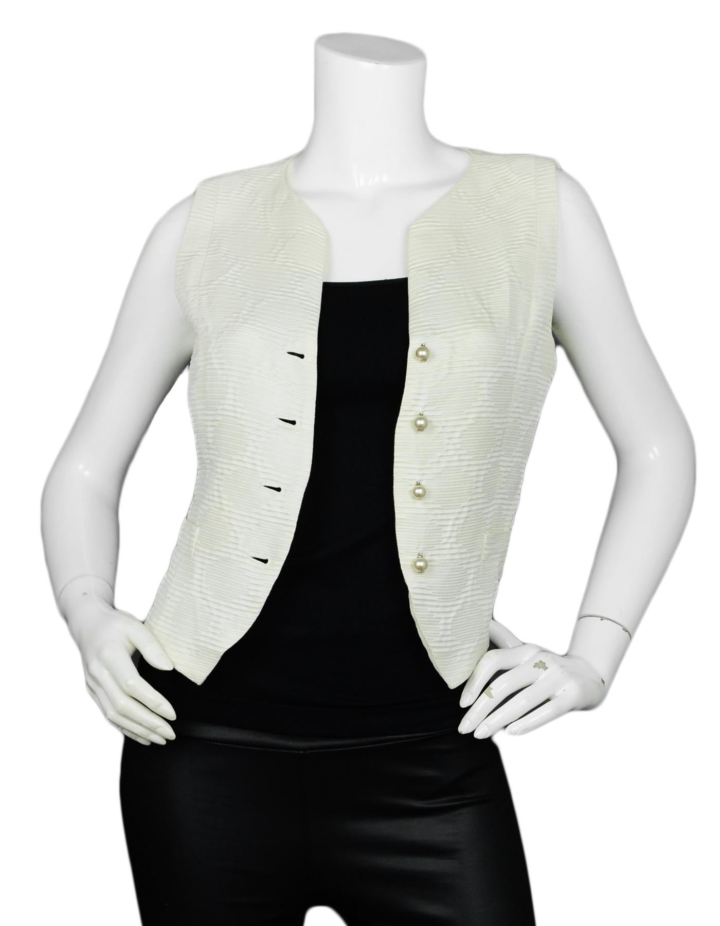 Chanel Cream Silk Vest w/ Pearl CC Buttons

Made In: France
Year of Production: 2014
Color: Cream
Materials: 100% Silk
Lining: 100% Silk
Opening/Closure: Front Pearl Buttons
Overall Condition: Excellent pre-owned condition, with the exception of a