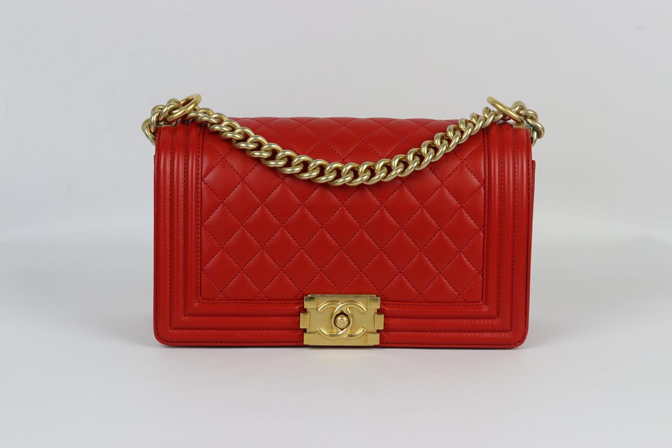 Chanel 2015 Boy medium quilted leather shoulder bag. Made from red-tone quilted leather with matching leather interior and antiqued-gold hardware chain shoulder straps. Red. Push lock fastening at front. Comes with authenticity card. Does not come