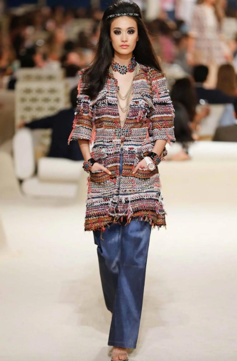 Step right off the Chanel runway with this amazing tweed coat! Circa 2015 from their resort collection, this tweed peacoat is crafted from a variety of colorful tweed and fringe. Features a deep v cut neckline, colorful fringe hem, 4 front pockets,