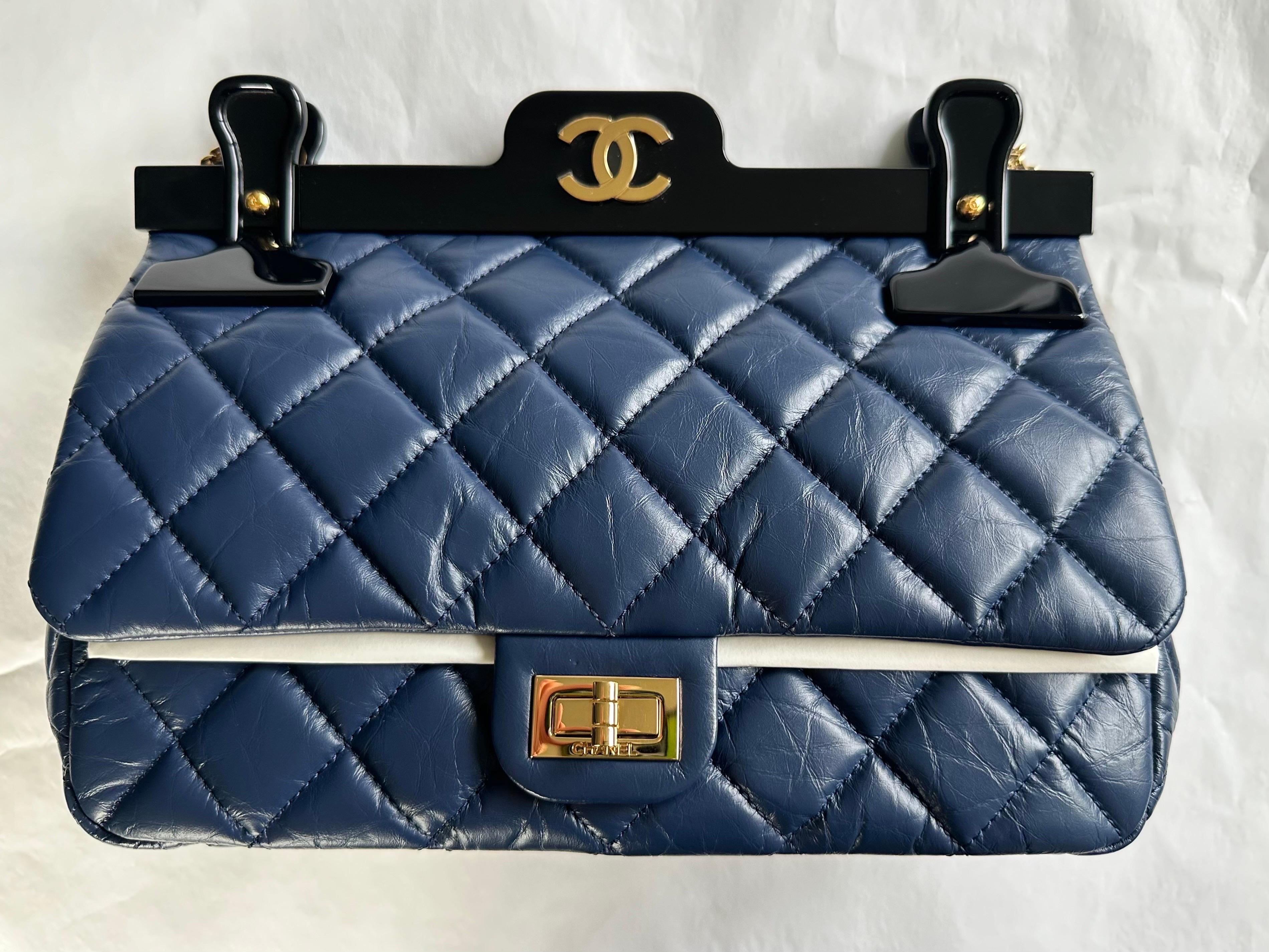 Chanel Limited Editiion 2.55 Reissue Rare Hanger Navy Blue Classic Flap Bag

Year: 2016
Gold tone hardware
Mademoiselle turn-lock closure
Navy blue calfskin
Reissue classic chain
Hanger detail with rear mirror
Classic back pocket
Burgundy leather