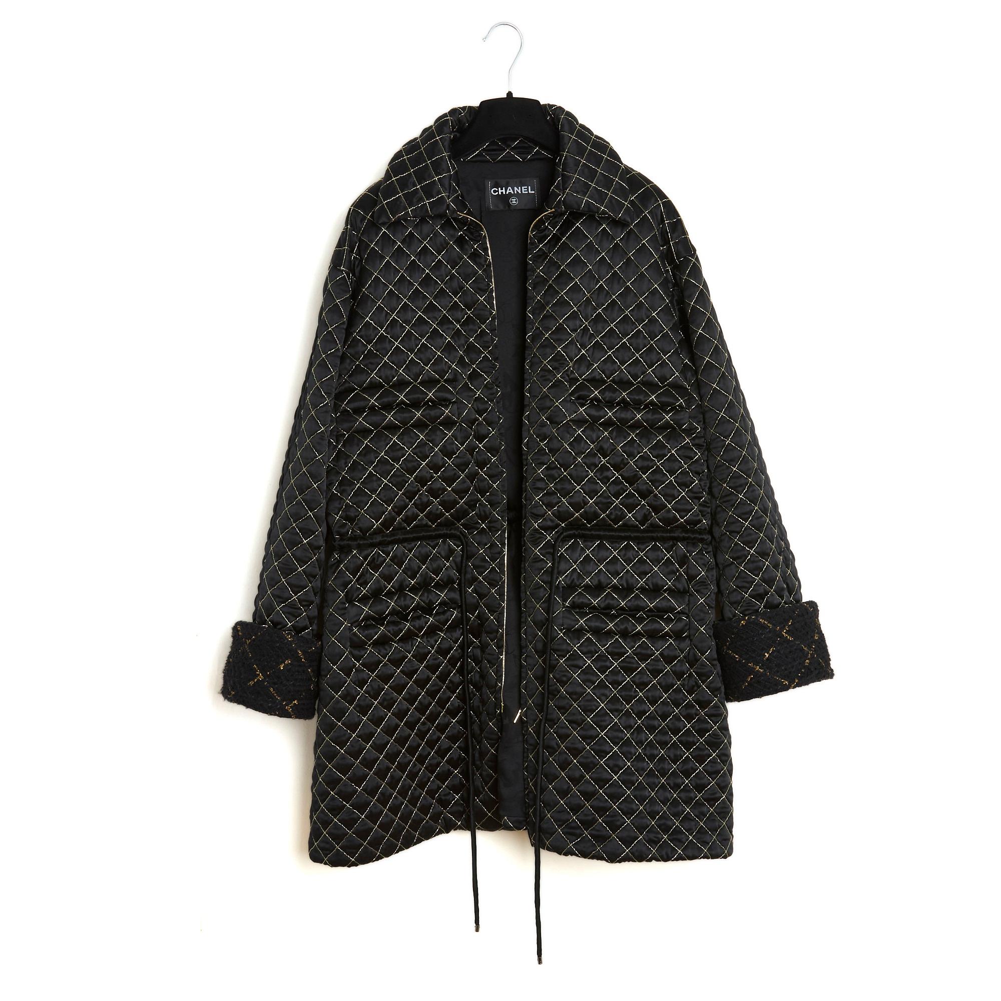 Chanel coat from the AW2016 collection by Karl Lagerfeld in black polyamide and silk satin quilted with gold thread, parka style, oversized volume, classic collar closed by a long double zip with gold metal pulls on the front, tightening tie (black