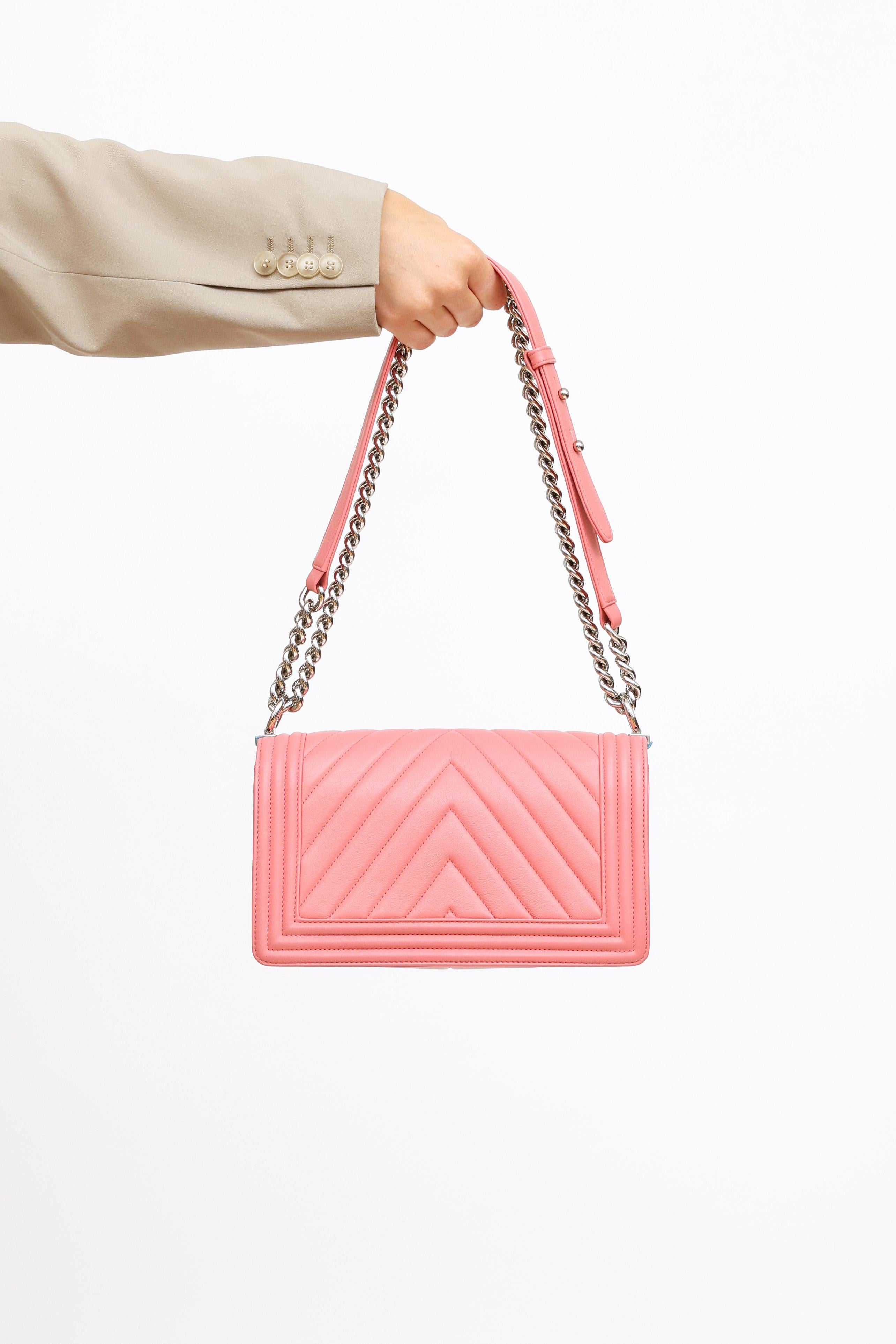 Pre-owned Chanel medium pink handbag featuring quilted chevron leather exterior, silver-toned hardware and interlocking logo push lock closure at front. Textile lining with 1 slip pocket at interior. From Series 2022 from 2016 collection.

Includes