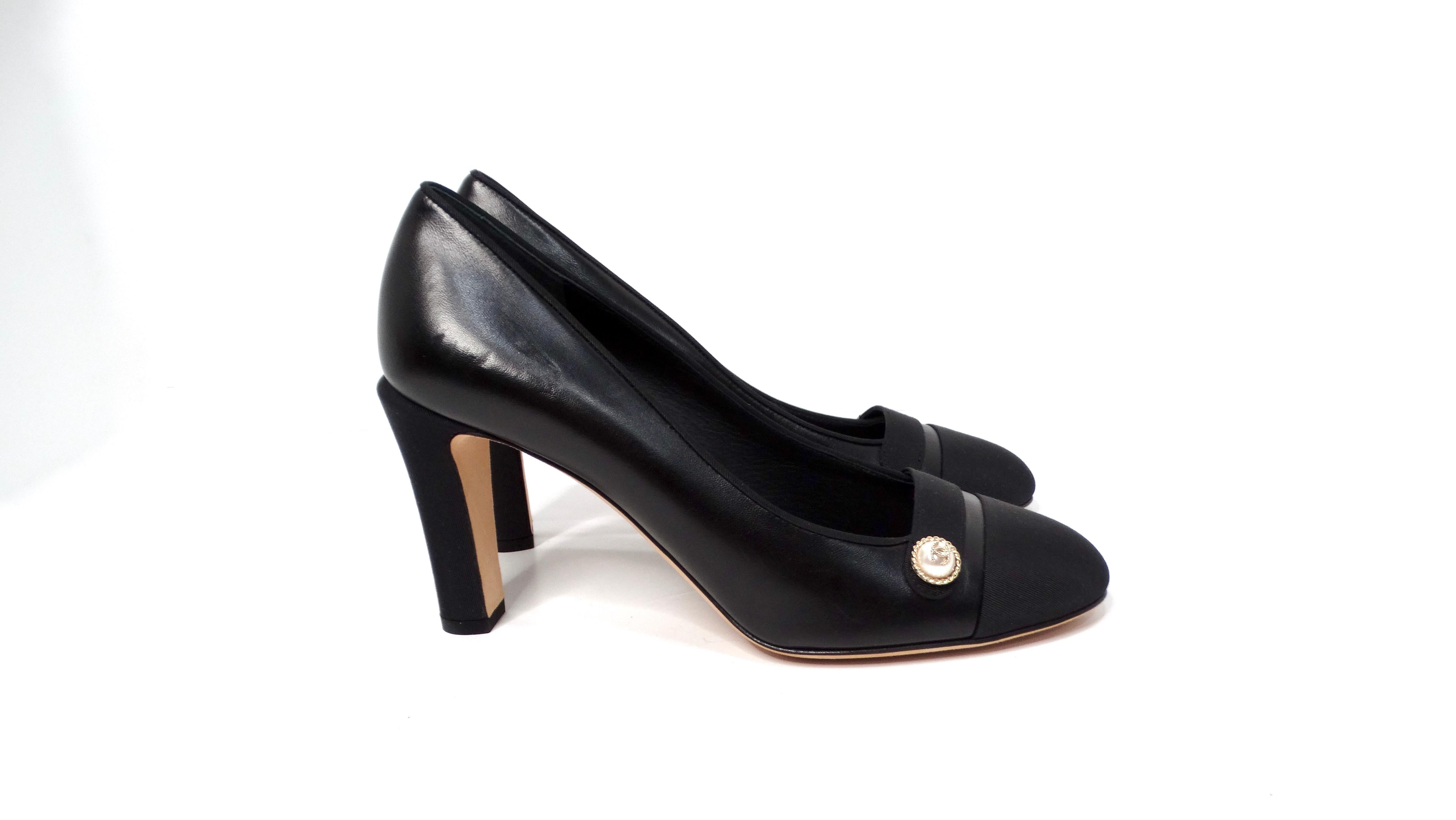 Elevate your footwear collection with the timeless elegance of Chanel 2017 Black Leather & Satin Pumps with Interlocking CC Logo Pearl. These monochrome heels showcase a sophisticated all-black design that epitomizes classic Chanel style. Crafted