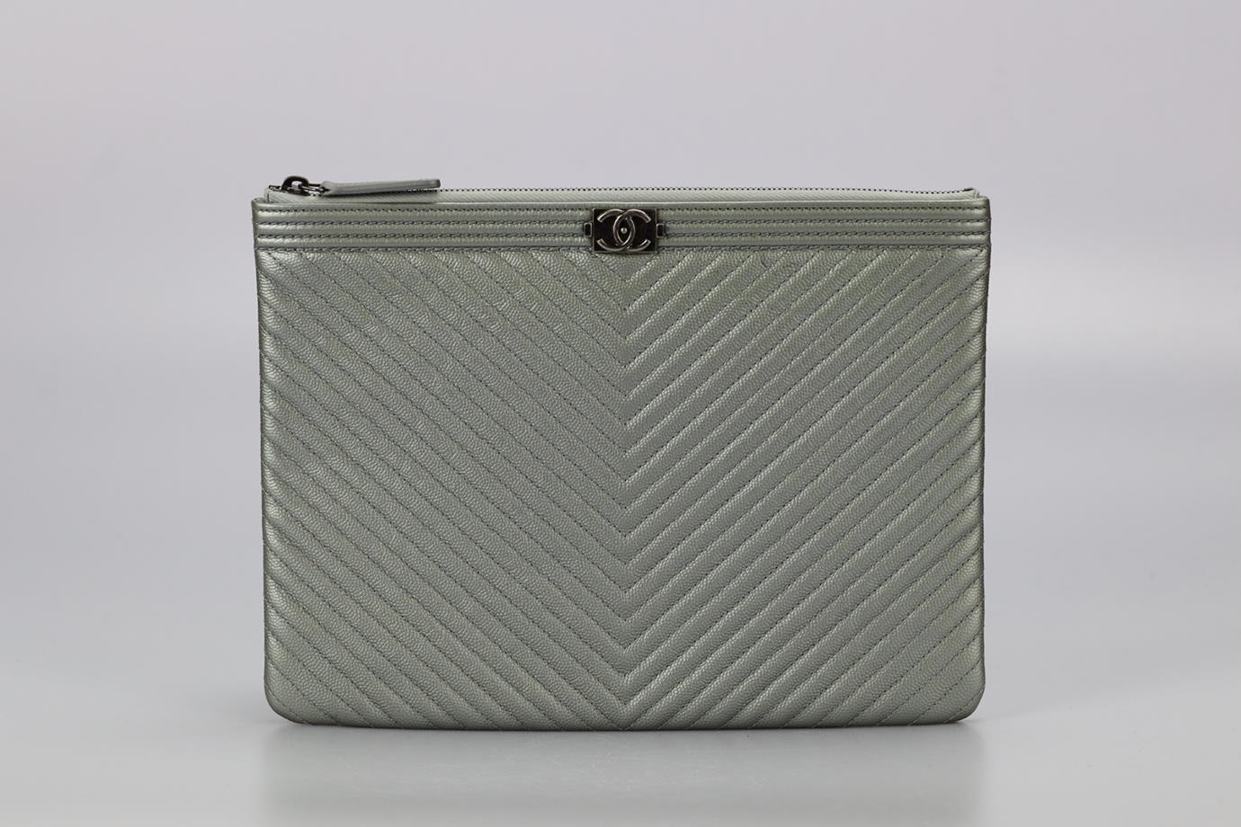 Chanel 2017 Cassic Boy O-case Chevron Caviar Leather Clutch. Silver. Zip fastening - Top. Comes with - authenticity card. Does not come with - dustbag or box. Height: 7.5 in. Width: 10.6 in. Depth: 0.4 in. Condition: Used. Very good condition -