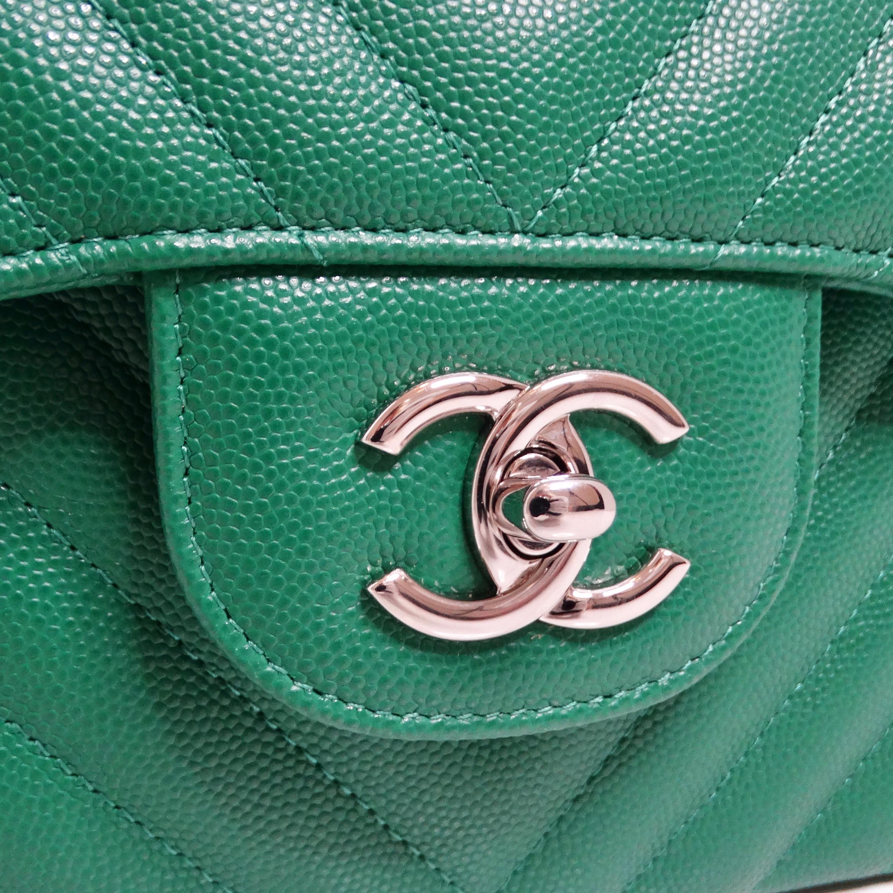 The Chanel 2017 Caviar Chevron Quilted Jumbo Flap Bag in dark green is a luxurious and timeless piece that embodies classic Chanel style with a modern twist. Crafted from caviar leather, this jumbo-sized shoulder bag features a distinctive chevron