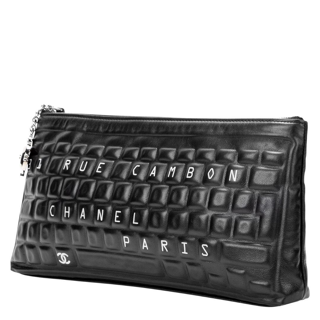 Cannot think of a more De Cru bag than this special Chanel! This beauty is so spirited and fun and in the typewriter/keyboard motif that is DE CRU!! Crafted in black lambskin leather with embossed leather keys that spell out the clever CHANEL