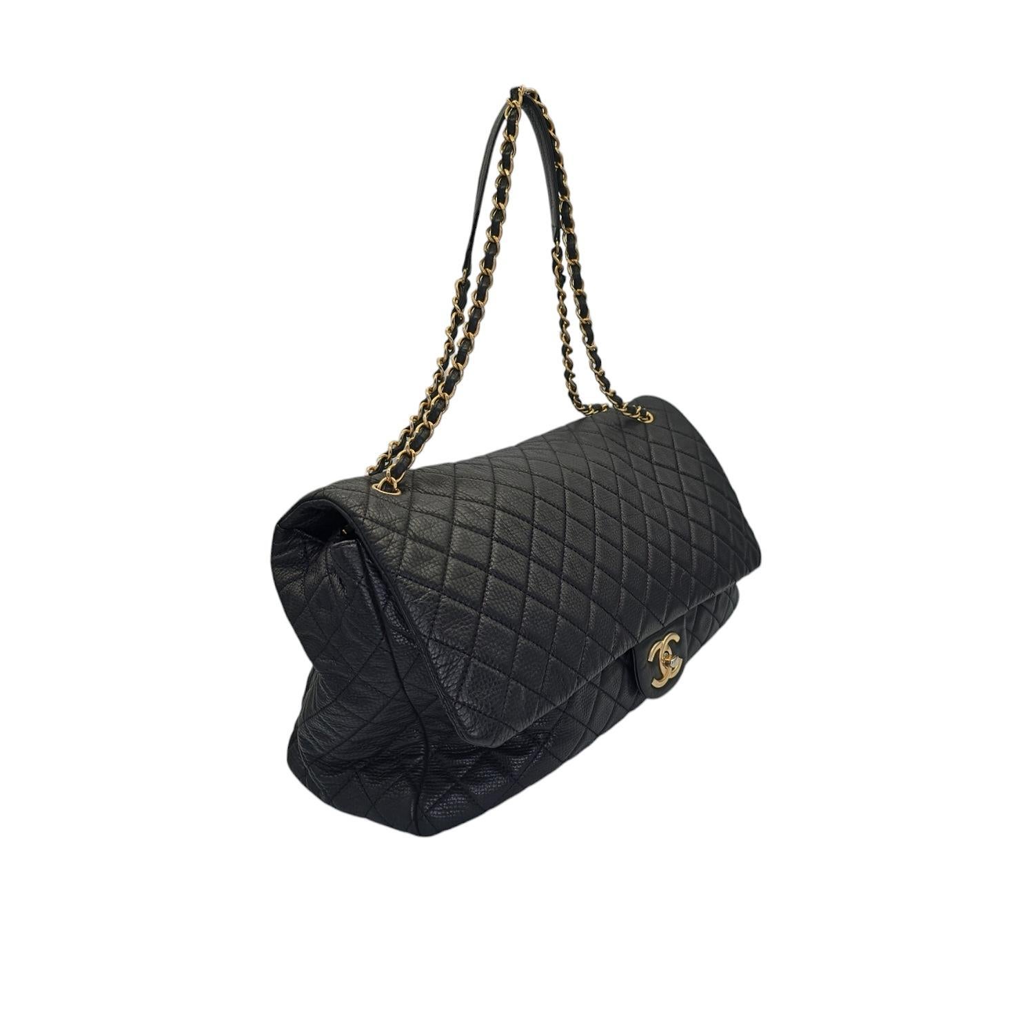 Unleash your inner chic with this Chanel 2018 Calfskin Quilted XXL Travel Flap Bag. The luxurious black calfskin leather is beautifully accentuated by the gold chain-link strap and gold-tone hardware. This spacious bag features multiple interior