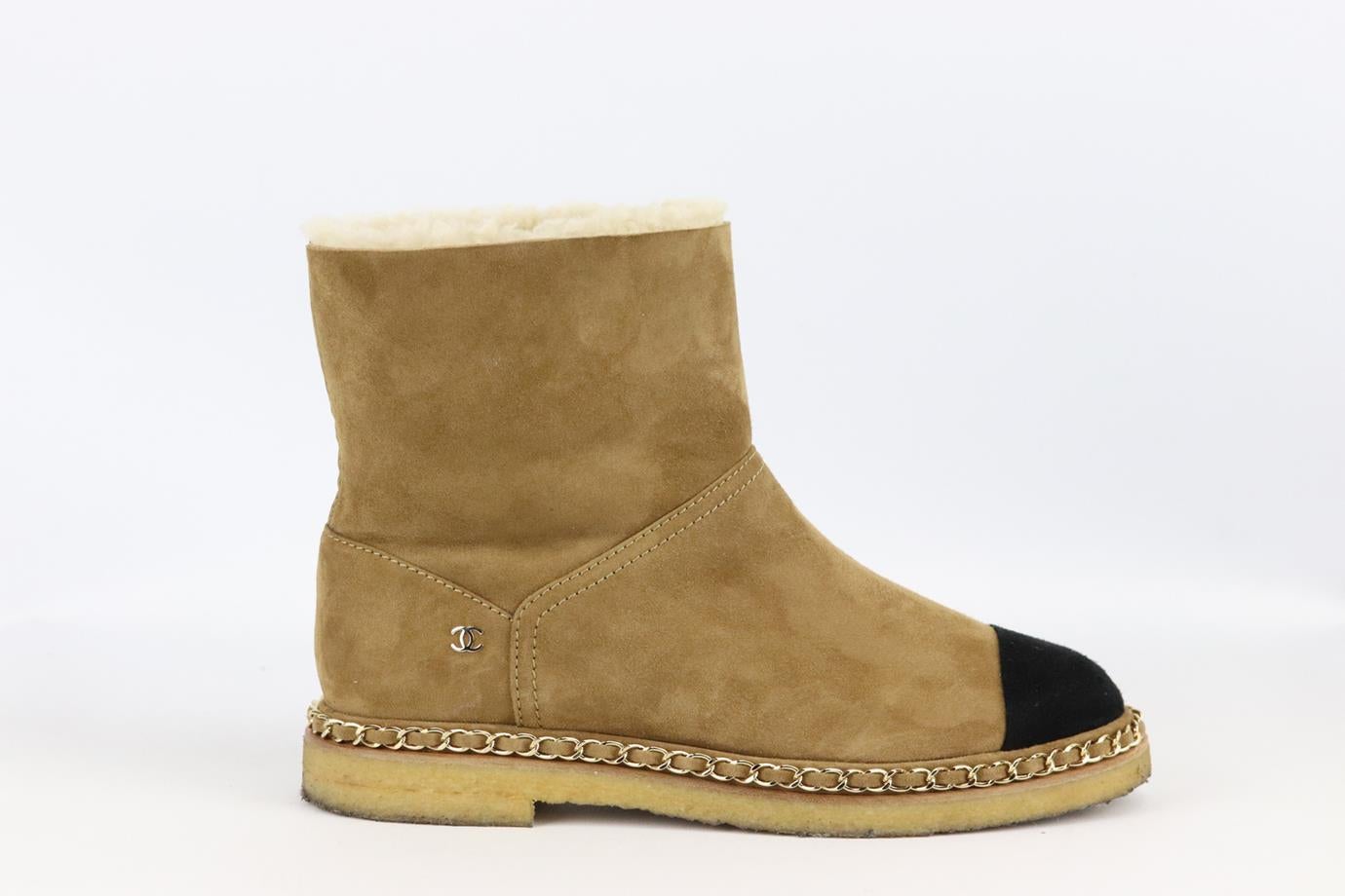 Chanel 2018 chain detailed suede ankle boots. Tan and black. Pull on. Does not come with box or dustbag. Size: EU 38.5 (UK 5.5, US 8.5). Outersole: 10.7 in. Shaft: 5.7 in. Heel: 1 in. Very good condition - Some wear to soles and upper material; see