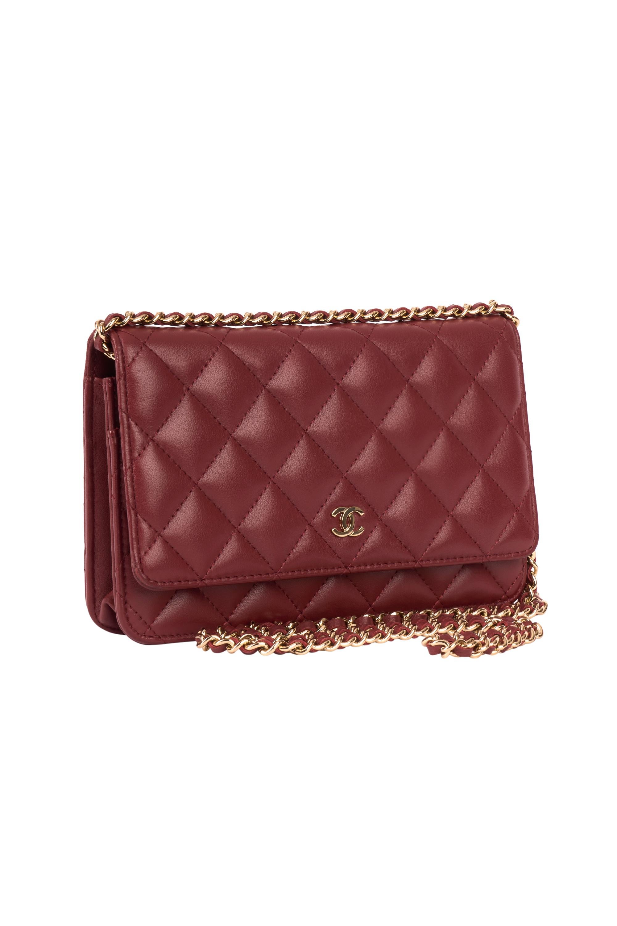 Chanel​ ​wallet​ ​on​ ​chain​ ​bag​ ​circa 2018 ​in​ dark ​red​ ​quilted​ ​lambskin leather. Features a gold​ ​metal​ ​trim and ​a​ ​gold​ ​metal​ ​chain​ ​handle​ ​interlaced​ ​with​ ​red​ ​leather​ ​allowing​ ​a​ ​shoulder​ ​or​ ​crossbody​