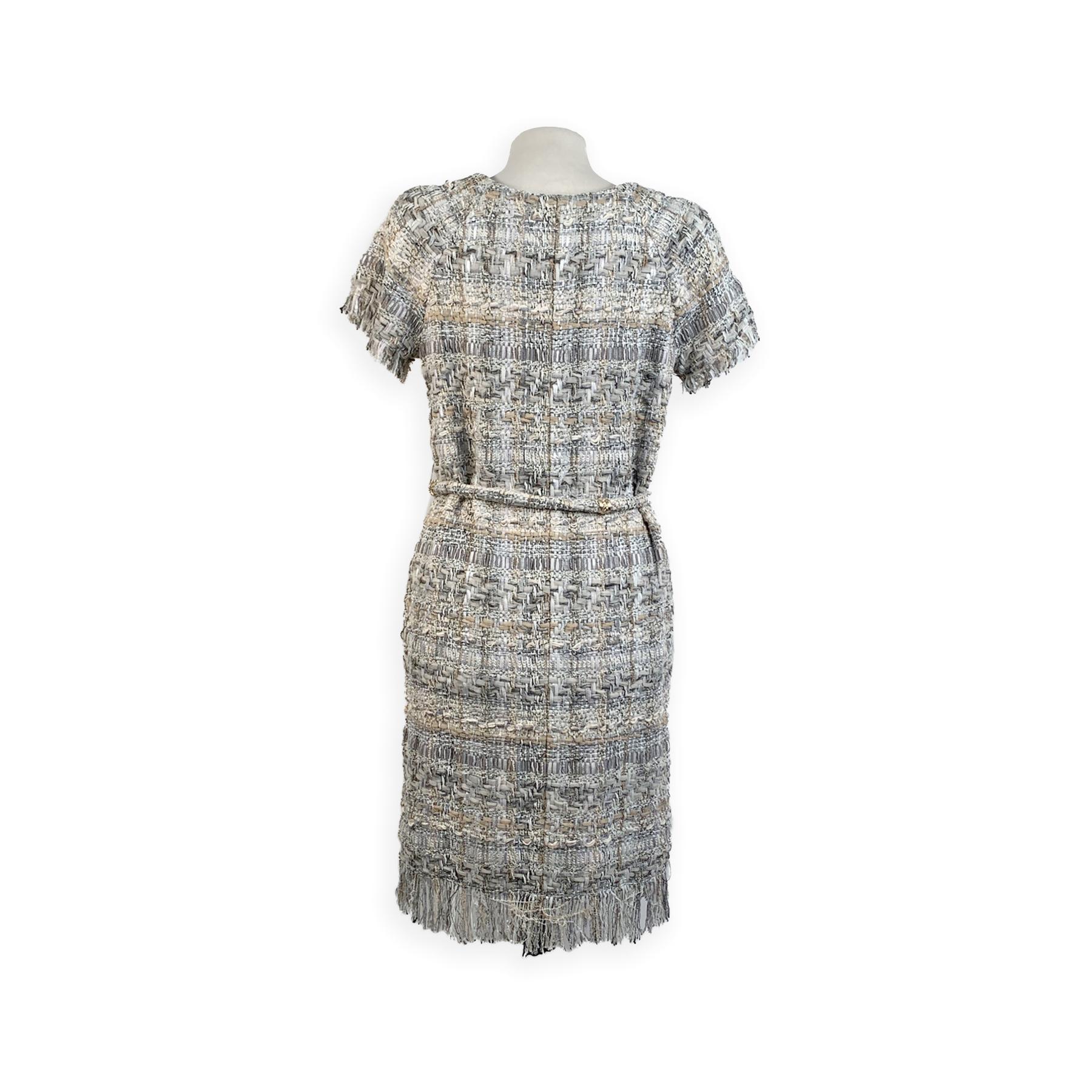 Chanel zip up grey and beige Lesage Tweed dress from the Chanel 2018 Cruise collection. The dress features short sleeve styling, a zip-through front, fringed trim and belted waistline. 2 pockets on the hips. Unlined. Composition: 30 % Nylon, 29 %