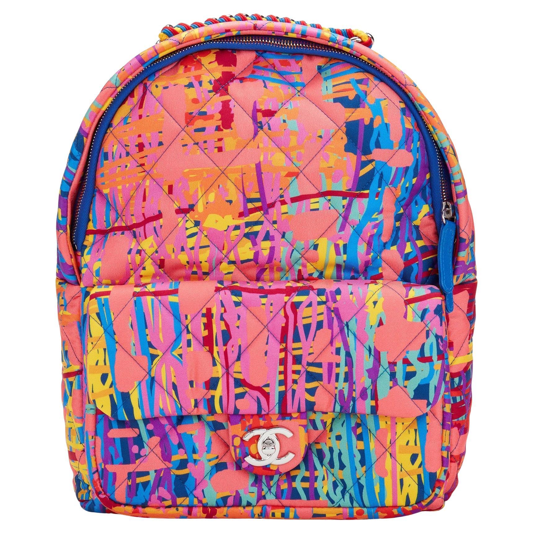 Chanel Multicolour Graffiti Medium Cloth Backpack 

Year: 2018 Spring 

Silver hardware
Braided lanyard top handle
Frontal classic flap pocket
Zip around pocket
Interior blue suede lining
Adjustable blue nylon straps
Made in Italy

12.6