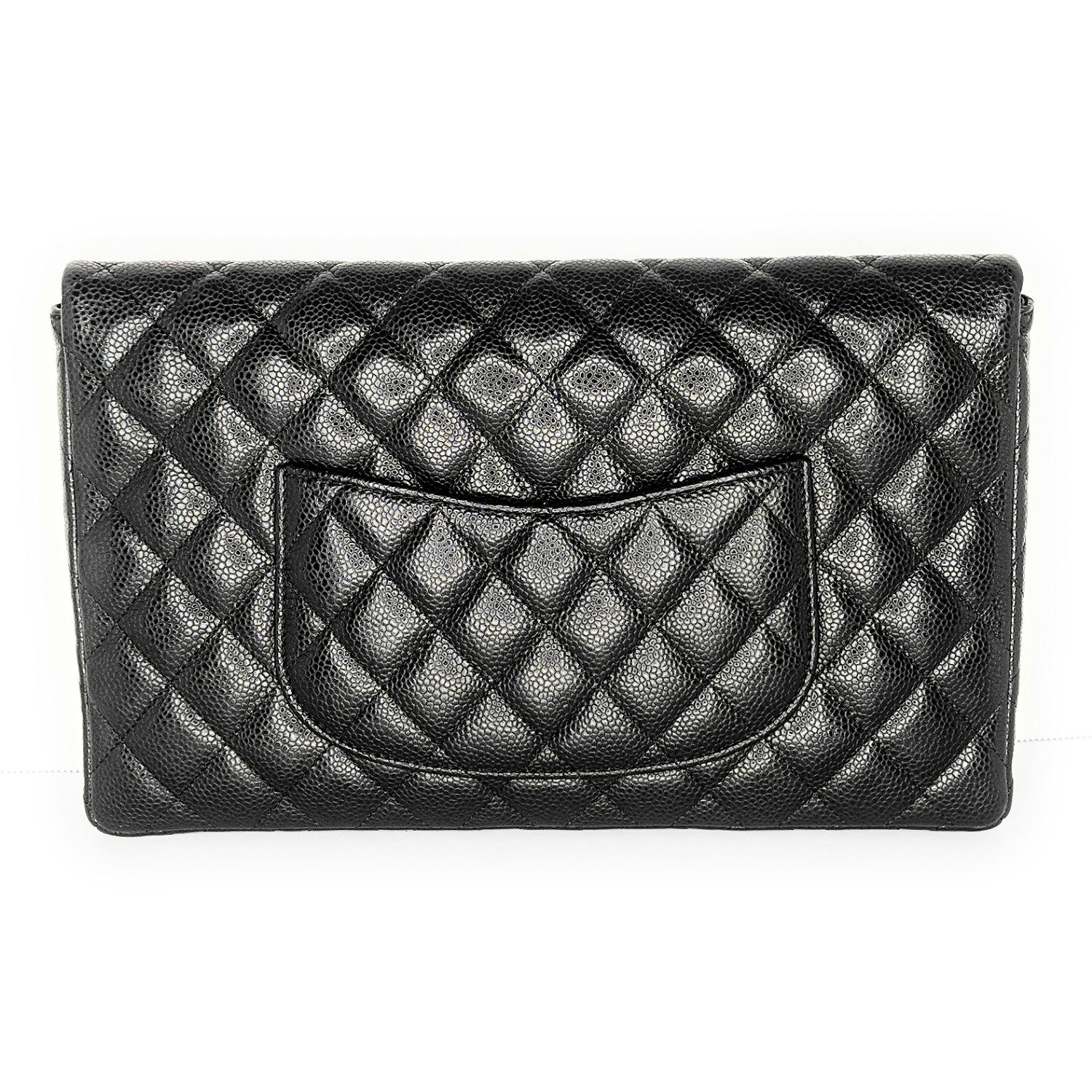 Black quilted leather Chanel Classic Flap clutch with ruthenium hardware, single patch pocket at back, tonal leather lining, single interior zip pocket, and turn-lock closure at front flap featuring CC logo adornment.

Designer: Chanel
Material: