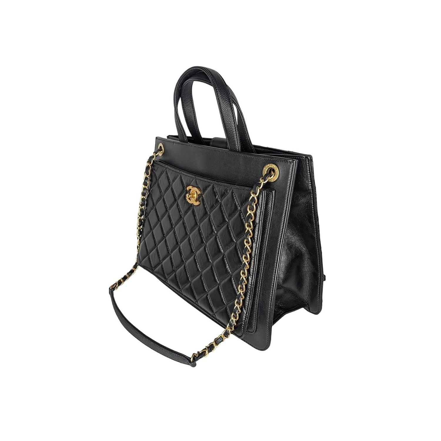 his stunning shoulder bag is crafted of smooth calfskin leather in black. The bag features aged gold chain link leather threaded shoulder straps with shoulder pads, dual flat top handles, and a frontal aged gold Chanel CC with a front quilted patch