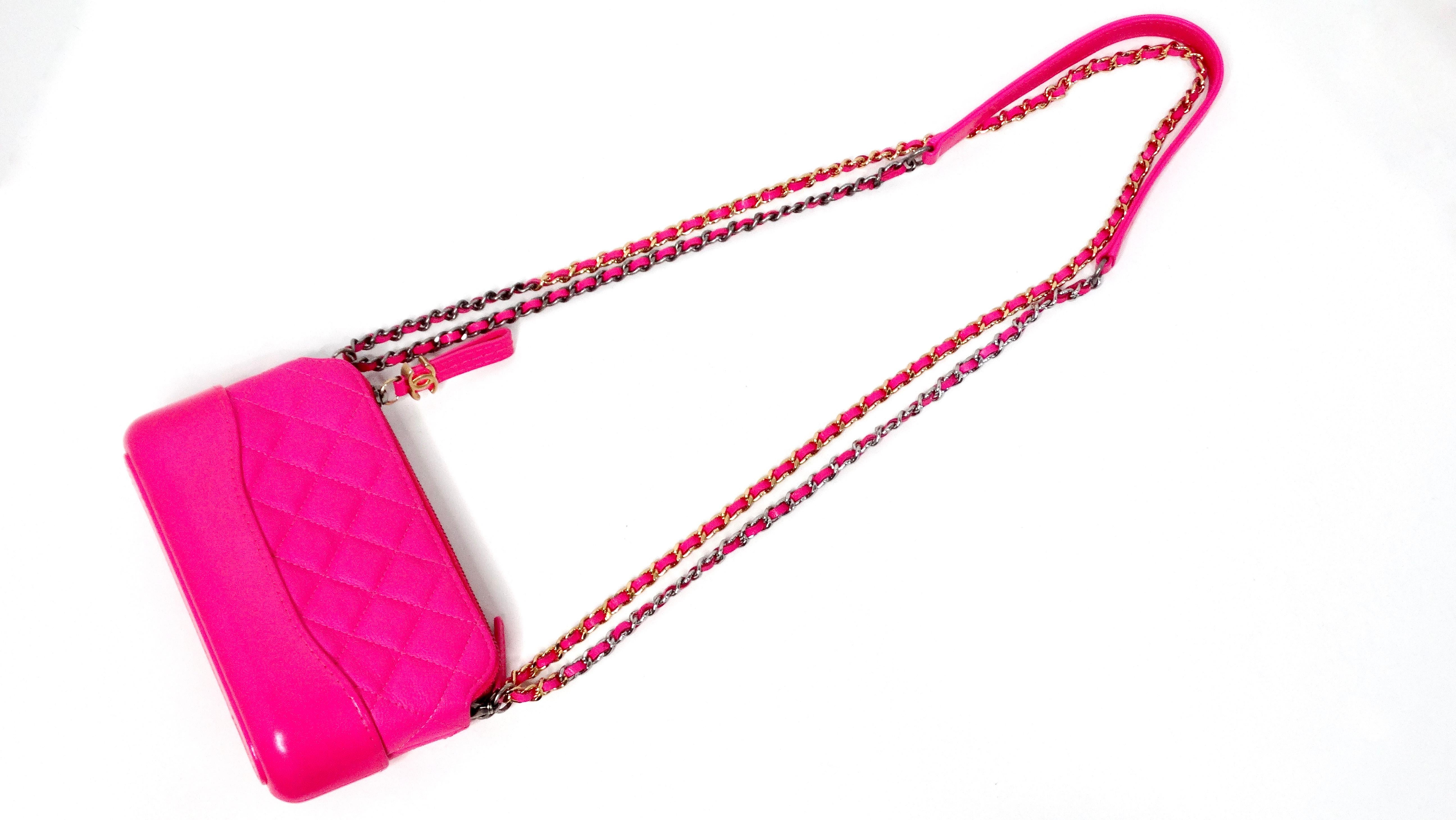 The Chanel 2019 Hot Pink Gabrielle Double Zip Clutch with Chain is a stunning blend of contemporary style and classic Chanel elegance. Crafted from luxurious quilted calfskin leather, its vibrant hot pink hue captures attention while maintaining a