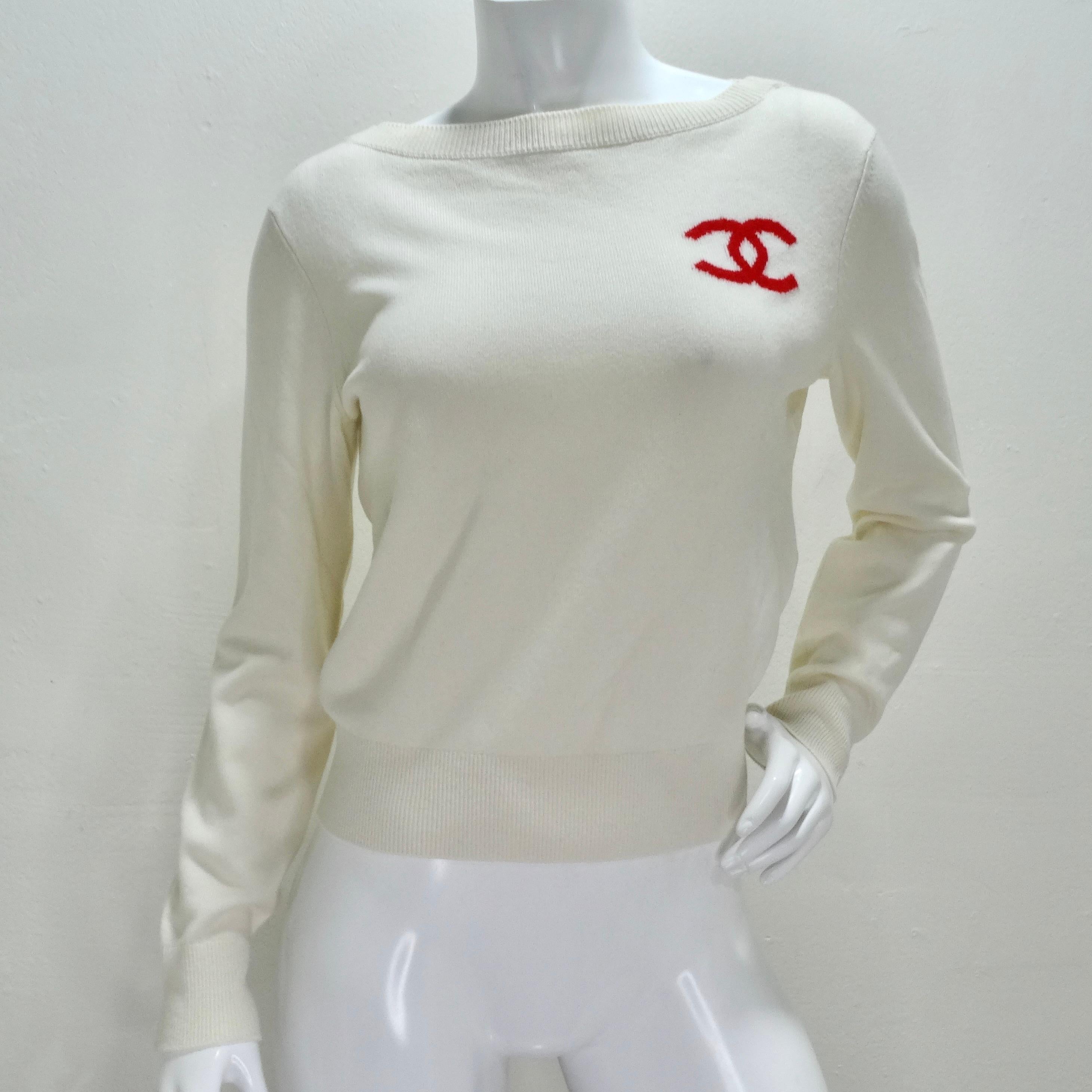 Indulge in timeless sophistication with the Chanel 2019 La Pausa Cashmere Sweater. This ivory crewneck sweater, crafted from sumptuous cashmere, exudes luxury and comfort. The iconic red interlocking 'C' logo on the front adds a signature touch of