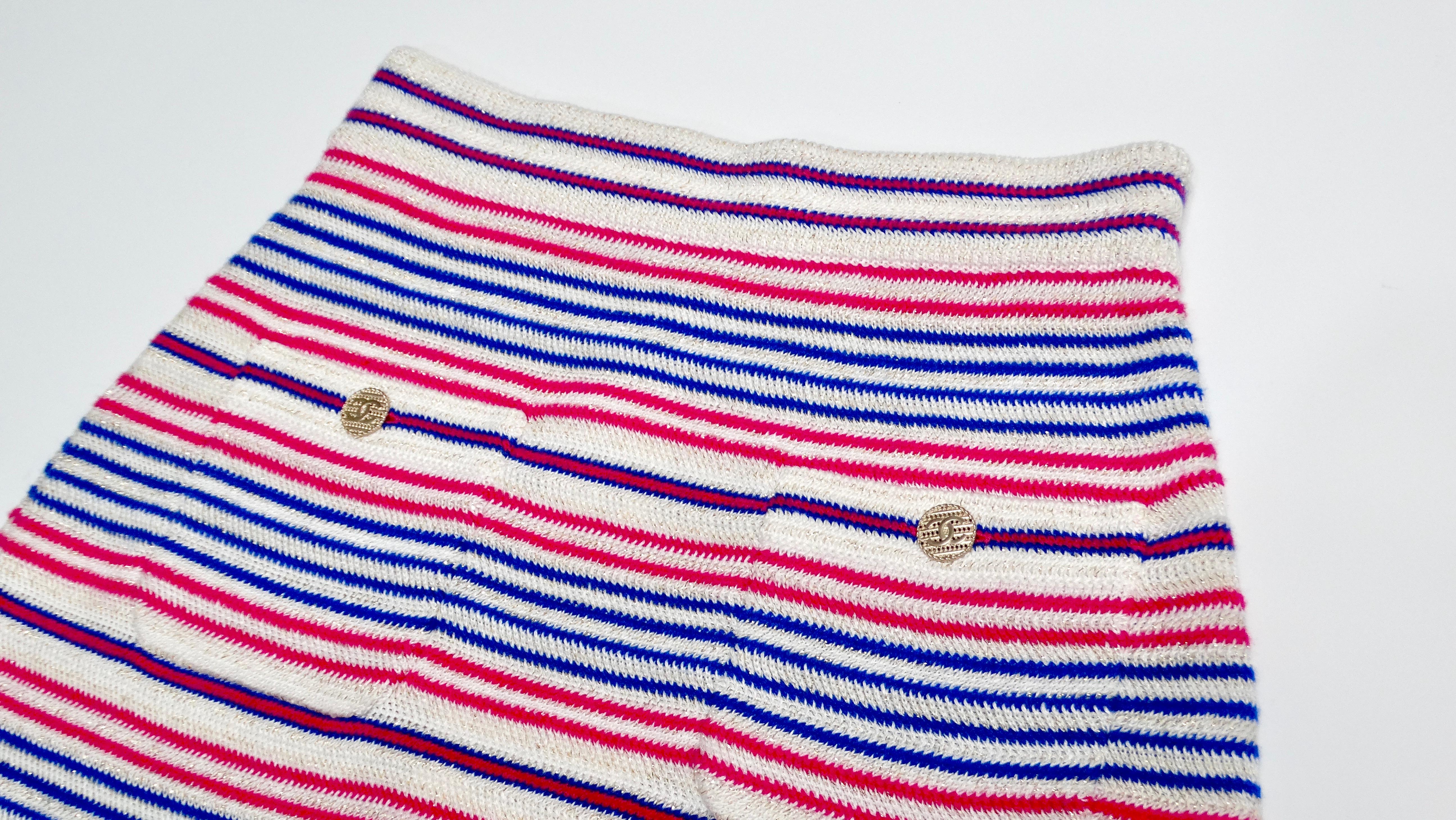 The Chanel 2019 La Pausa Striped Knit Mini Skirt is a vibrant and chic piece that exudes a playful yet sophisticated charm. Drawing inspiration from classic nautical themes, this skirt features bold stripes in berry pink, blue, and ivory, with a
