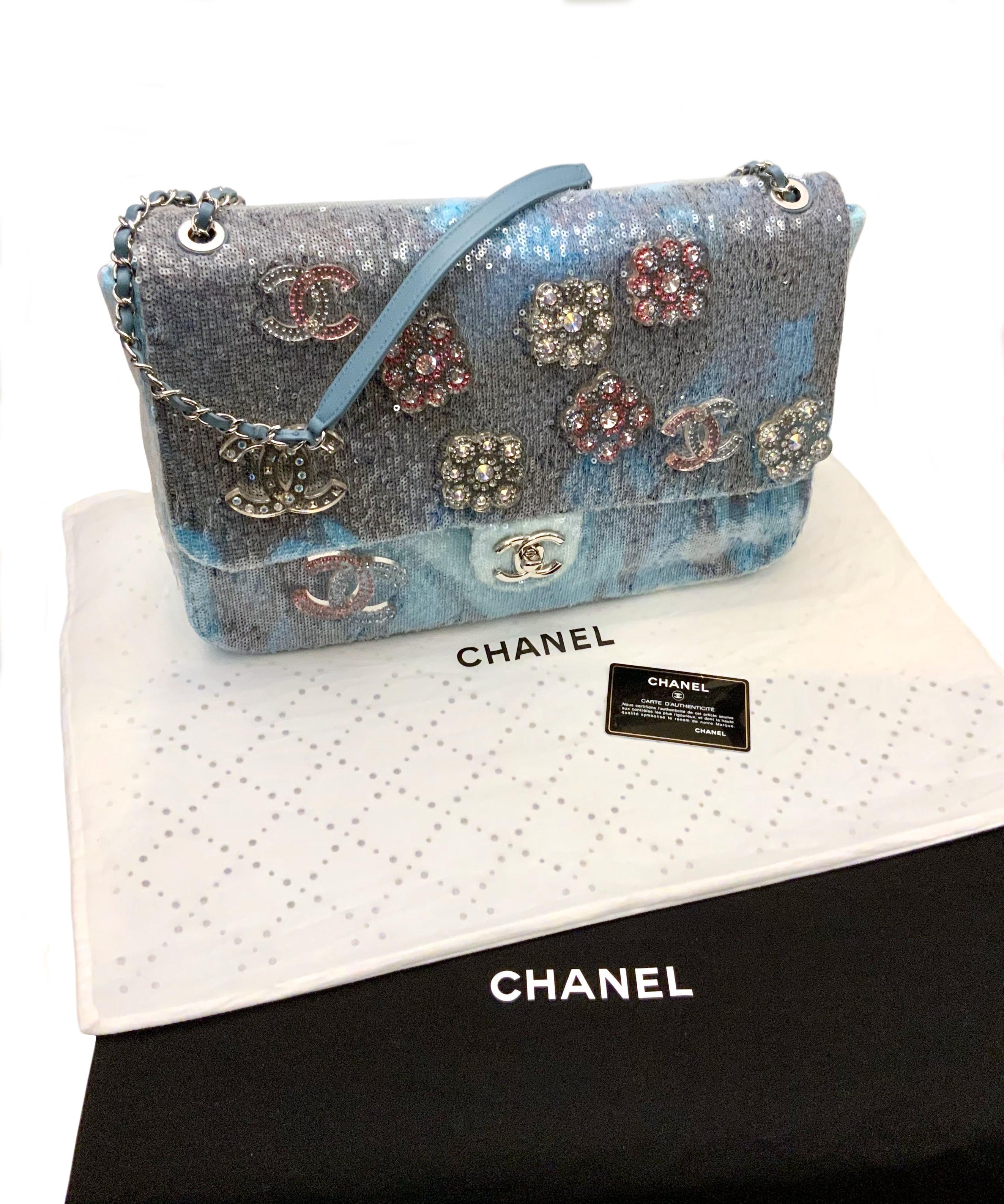 This new pre-owned stunning Limited Edition large flap bag from the house of Chanel is realized in smooth calfskin leather with clear sequin embellishments throughout exterior.
It features the CC turn-lock logo in silver-tone and some resin camelia