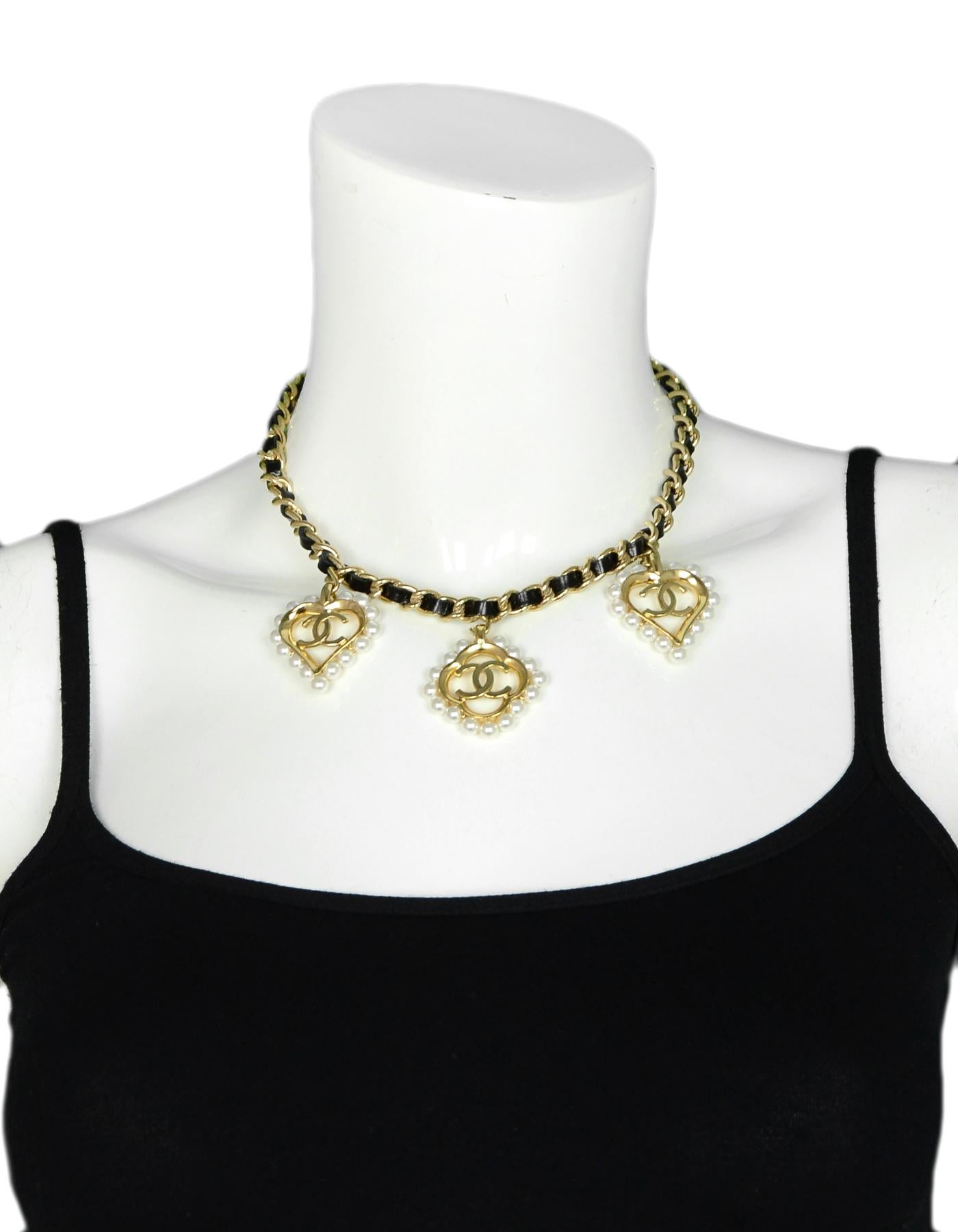 Chanel 2019 Leather Laced Chain Necklace w/ Faux Pearl Heart & Flower CC Charms

Made In: France
Year of Production: 2019
Color: Gold, Black
Materials: Metal, Leather, Pearls
Hallmarks: 