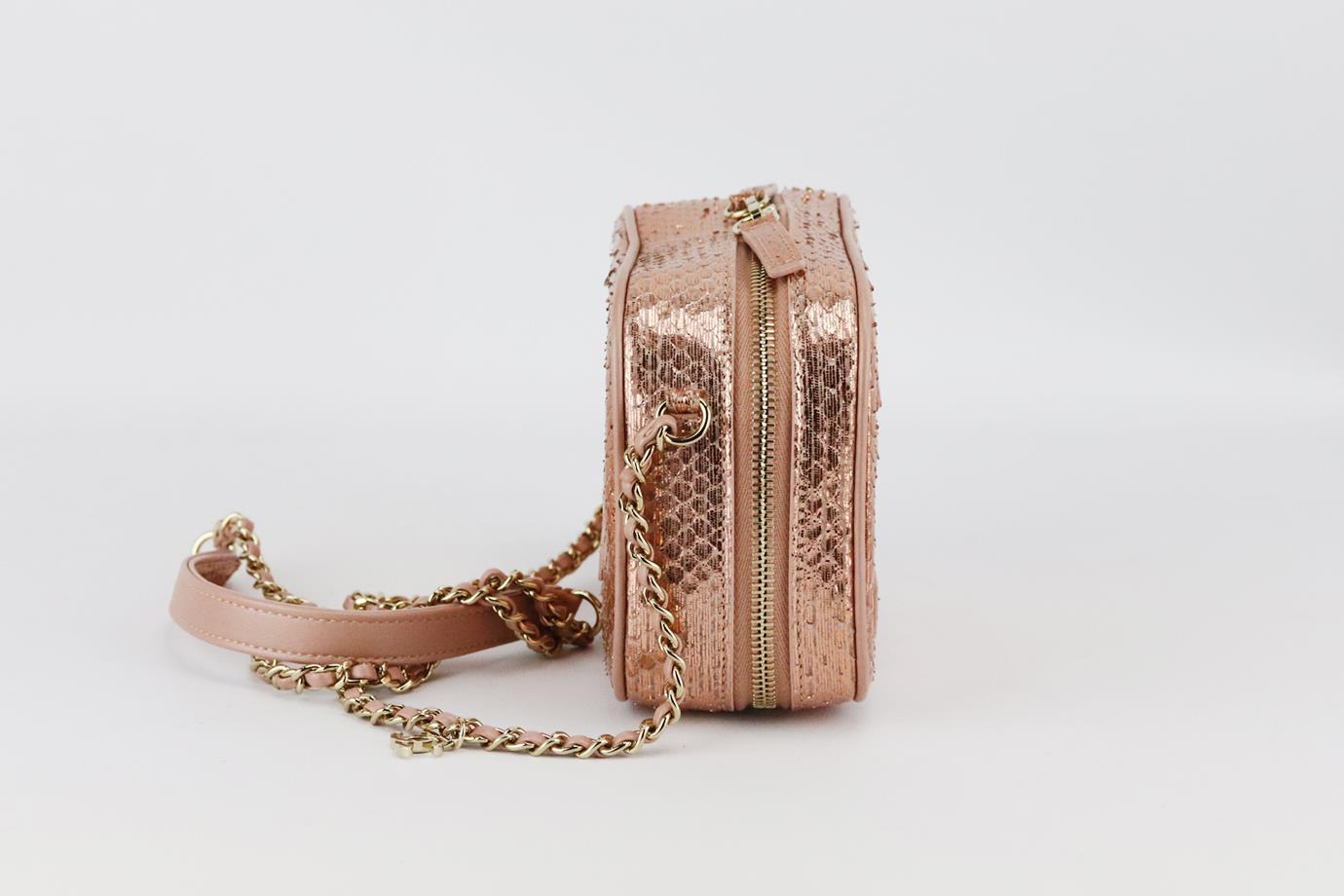Chanel 2019 Mania Camera Case metallic python and leather shoulder bag. Made from rose-gold python and leather with large CC on the front, it has a large internal compartment with slit pocket. Rose-gold. Zip fastening at top. Does not come with