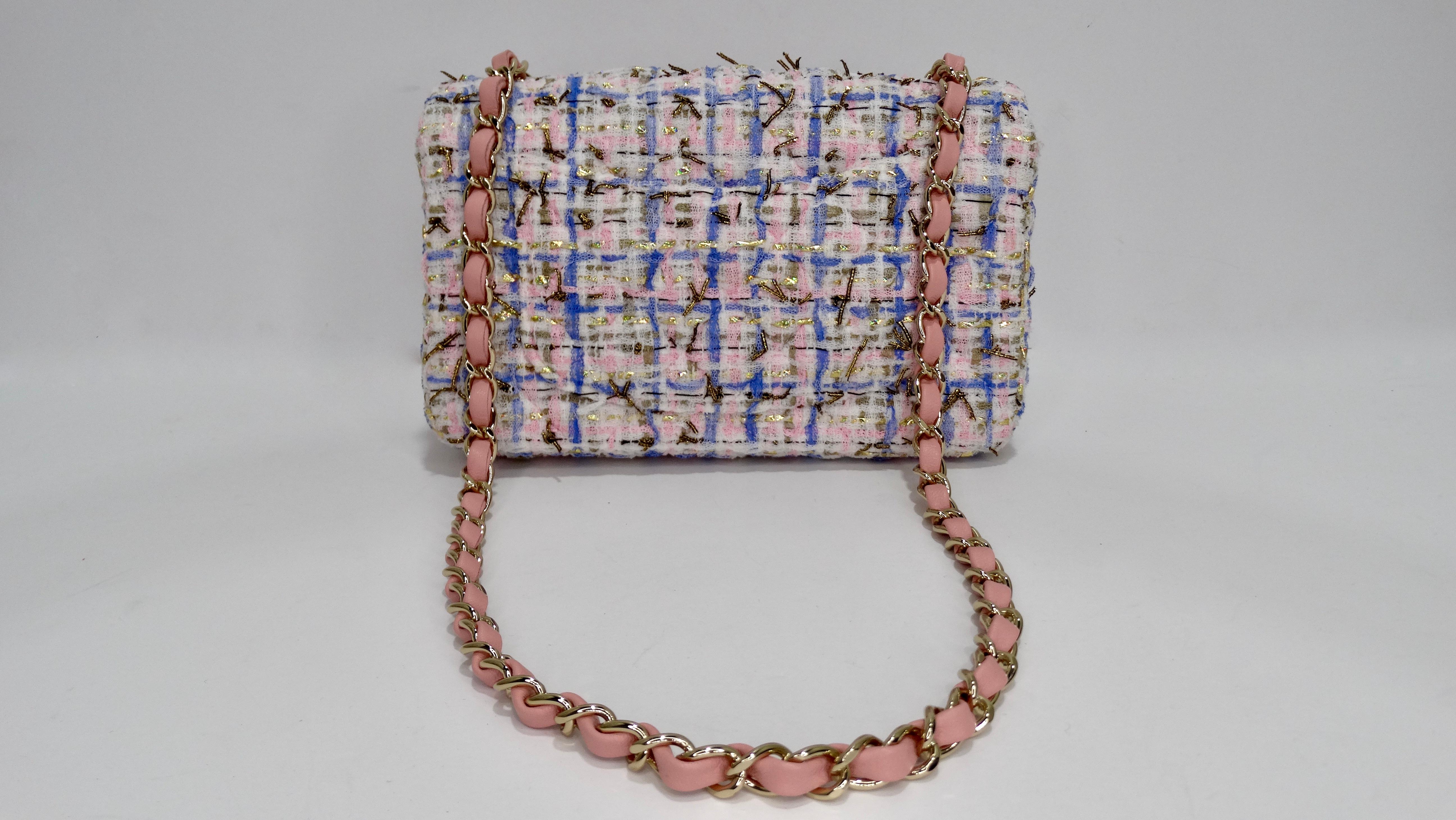 Add this adorable Chanel to your collection! Circa 2019 from their Cruise collection, this chic mini flap bag is crafted from pink, blue, gold and metallic gold tweed fabric with Chanel's signature quilted stitching. The bag features light gold