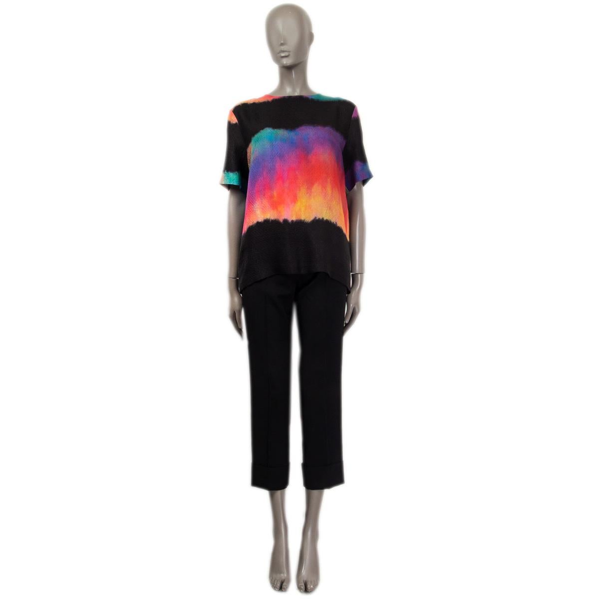 100% authentic Chanel short sleeve shift silk blouse in black, orange, green, purple, pink tie-dye silk (100%). Metiers d'Art 2019/20. Closes with four metal buttons which are embellished with a lions head on the back. Comes with an additional