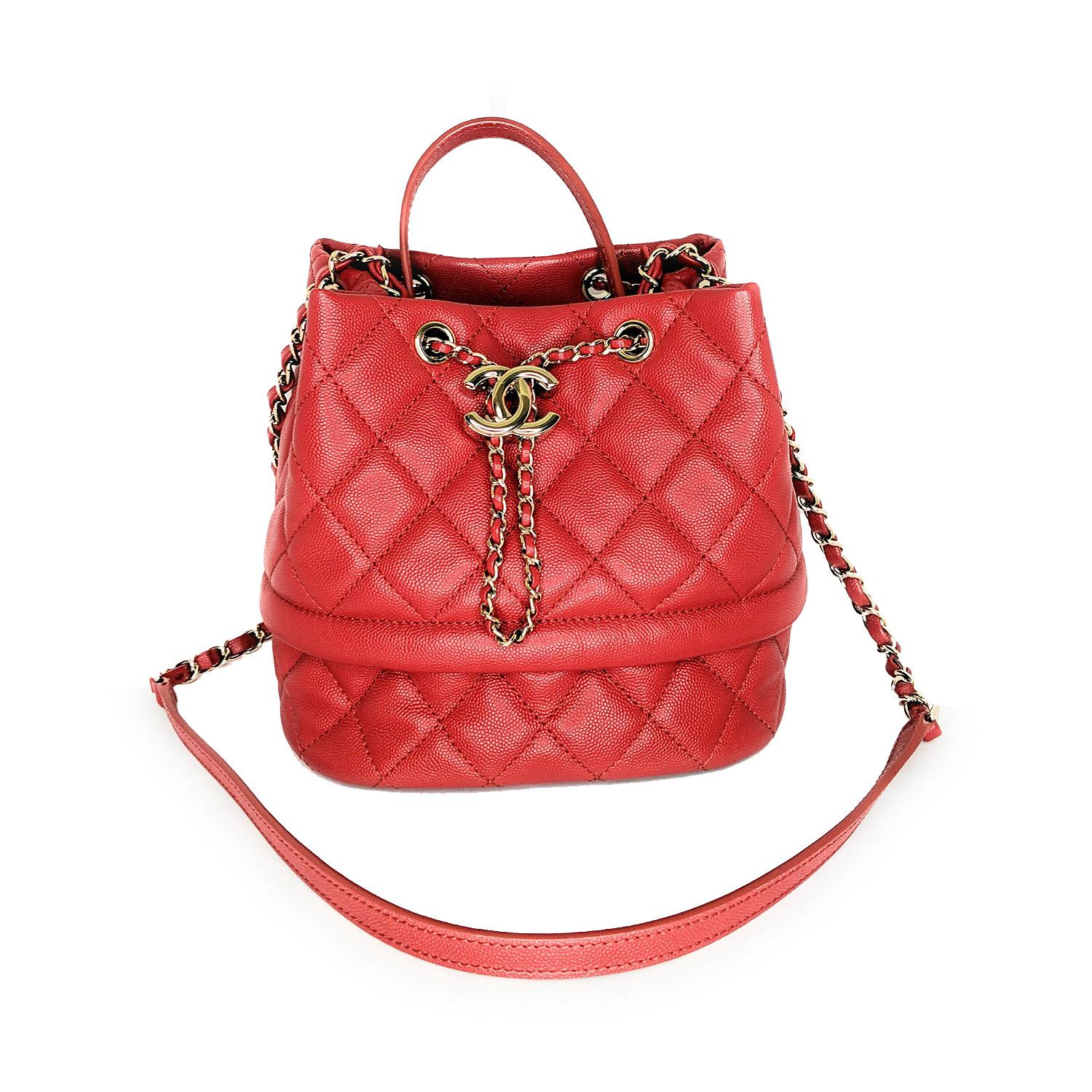 This stylish handbag is crafted of diamond-stitched grained calf leather in red. The bag features a top leather handle, a light gold chain threaded with leather and a shoulder pad. This chic bag is detailed with a leather and chain cinch cord with a