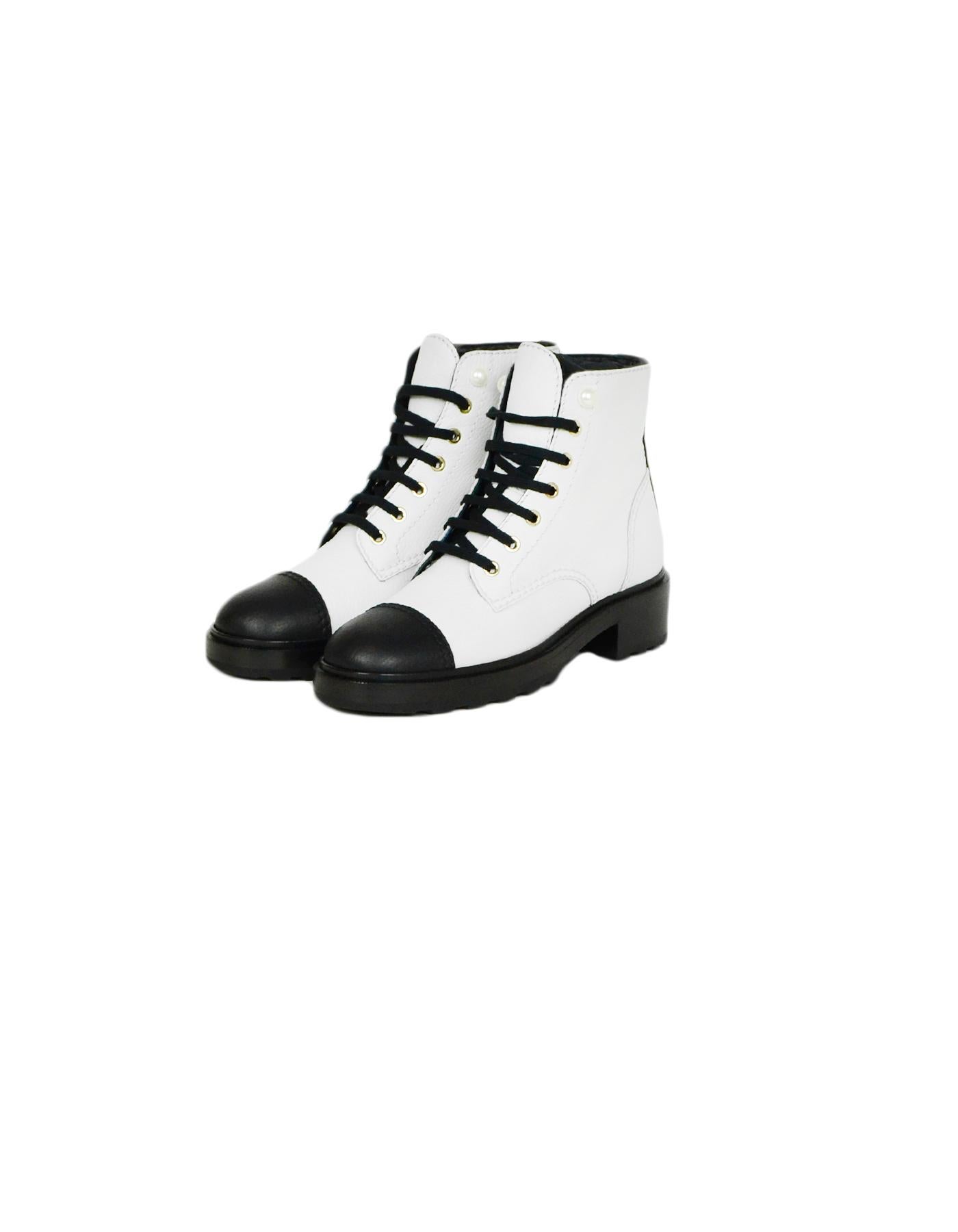 Chanel 2019 White Black Leather CC Lace Up Boots sz 39

Made In: Italy
Year of Production: 2019
Color: White, Black
Hardware: Silvertone
Materials: Leather
Closure/Opening: Lace-up
Overall Condition: Excellent pre-owned condition, like new
Estimated
