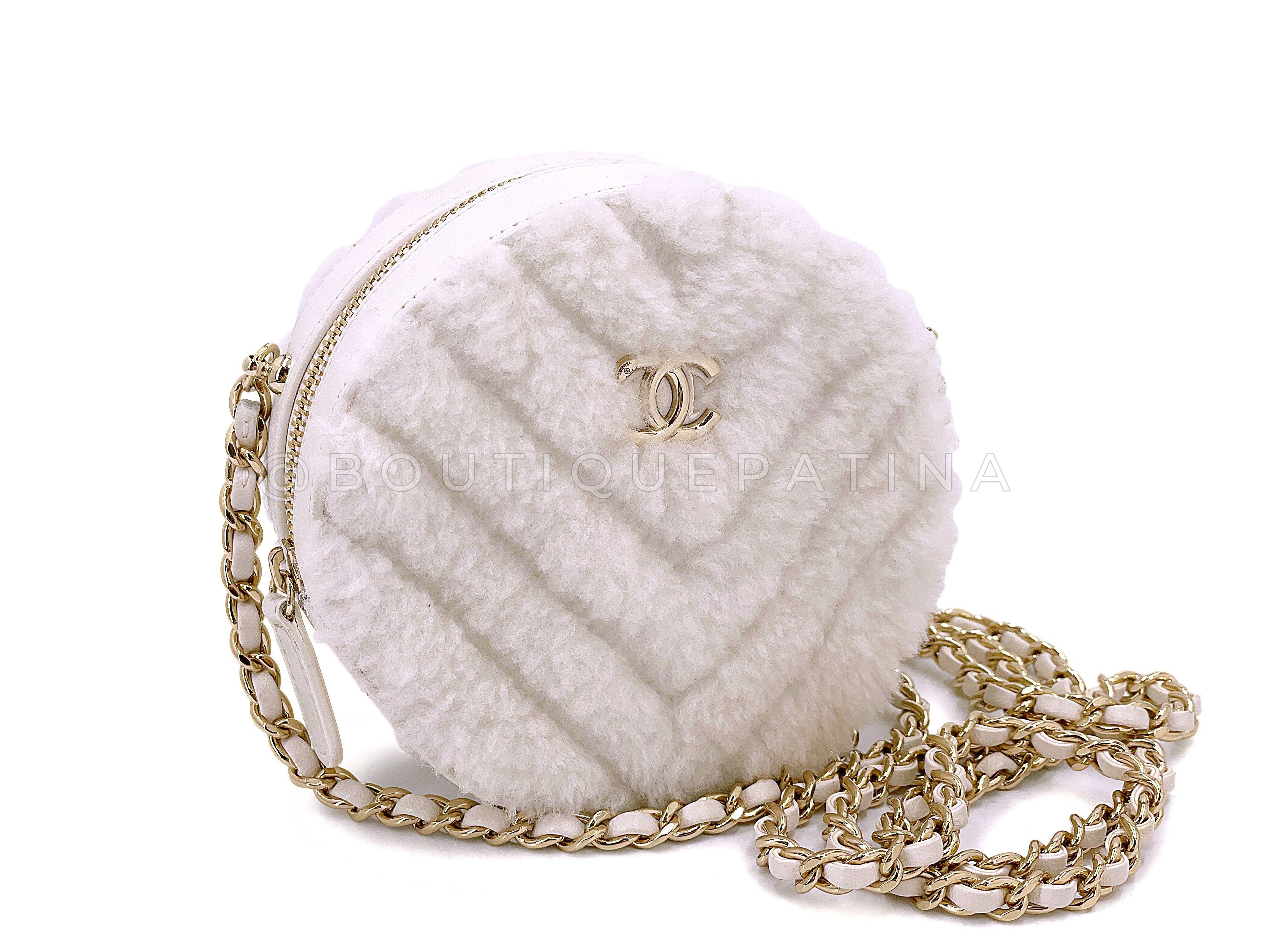 Store item: 67850
ITEM is a cute and whimsical addition with crossbody use. 

Zip top and compartment will carry coins and cards, no phone. 

In white ivory shearling and gold hardware.  For 20 years, Boutique Patina has specialized in sourcing and