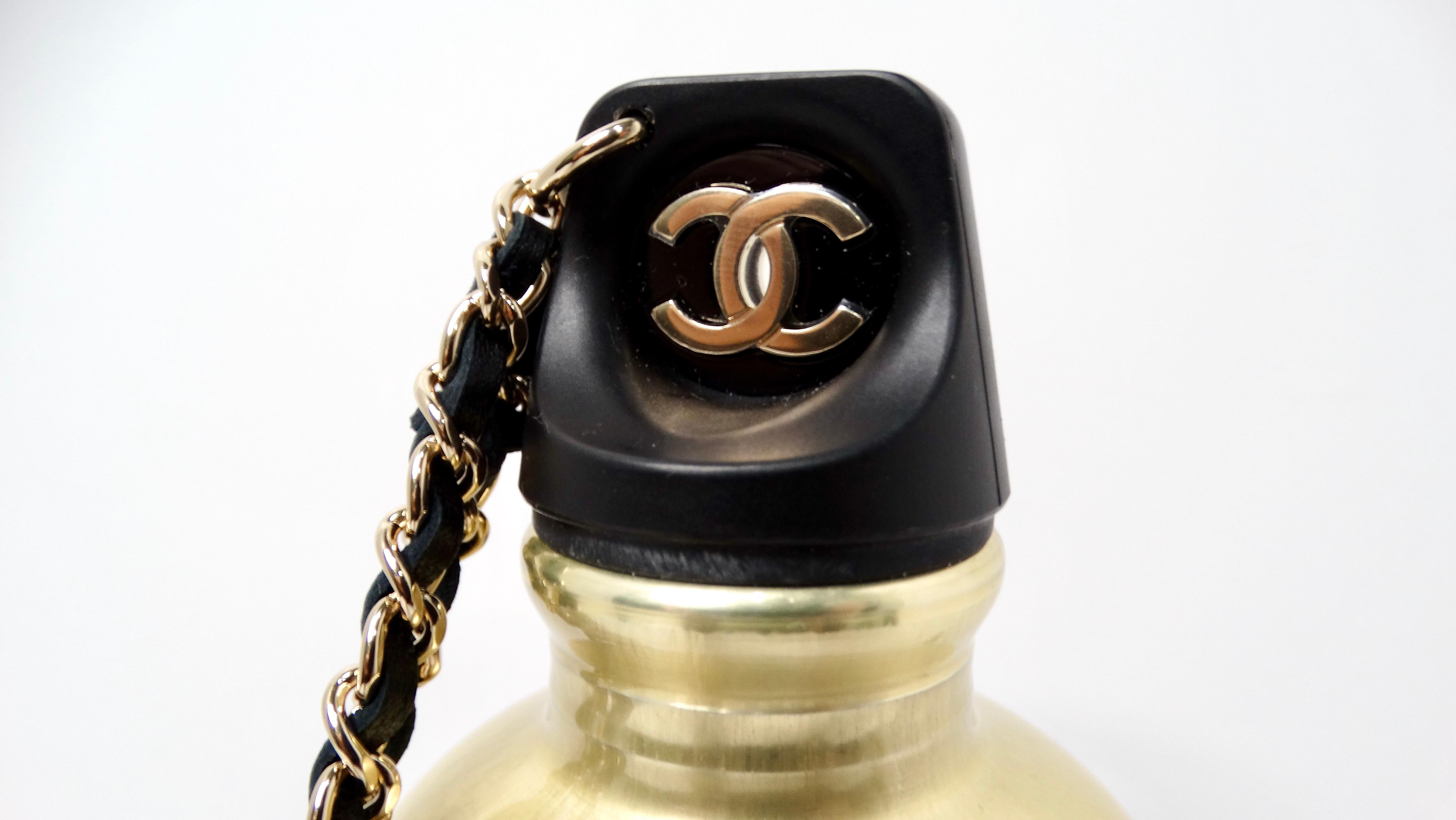 The Chanel 2020 Black Quilted Lambskin Leather & Gold-Tone Metal Water-Bottle Bag is an exquisite fusion of luxury and functionality, designed for the modern individual who appreciates style in every detail. Crafted from sumptuous black lambskin,