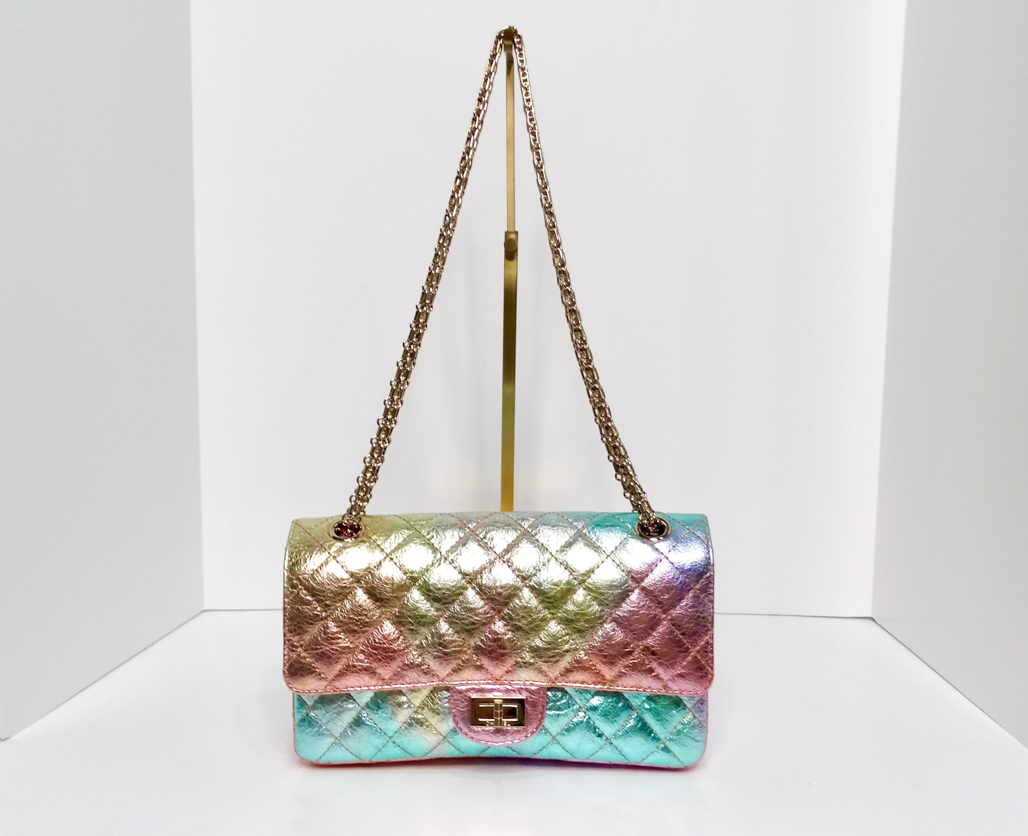 The Chanel 2020 Rainbow Metallic Goatskin Small 2.55 Reissue Flap Bag is a stunning addition to any fashionista’s collection. This exquisite bag captivates with its vibrant rainbow metallic finish, showcasing a beautiful sheen that changes with the