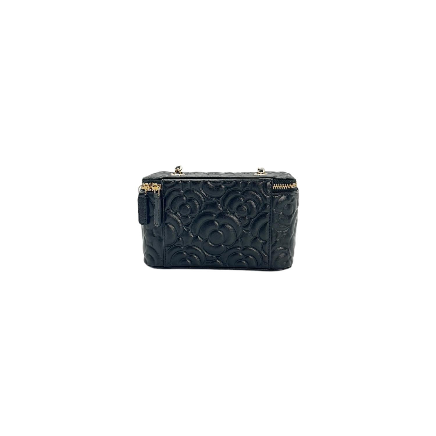 Indulge in luxury with the Chanel 2021 Black Camellia Vanity Case. Crafted from premium leather with golden hardware, this designer piece exudes sophistication. The compact size is perfect for your essentials, while the interior features card slots