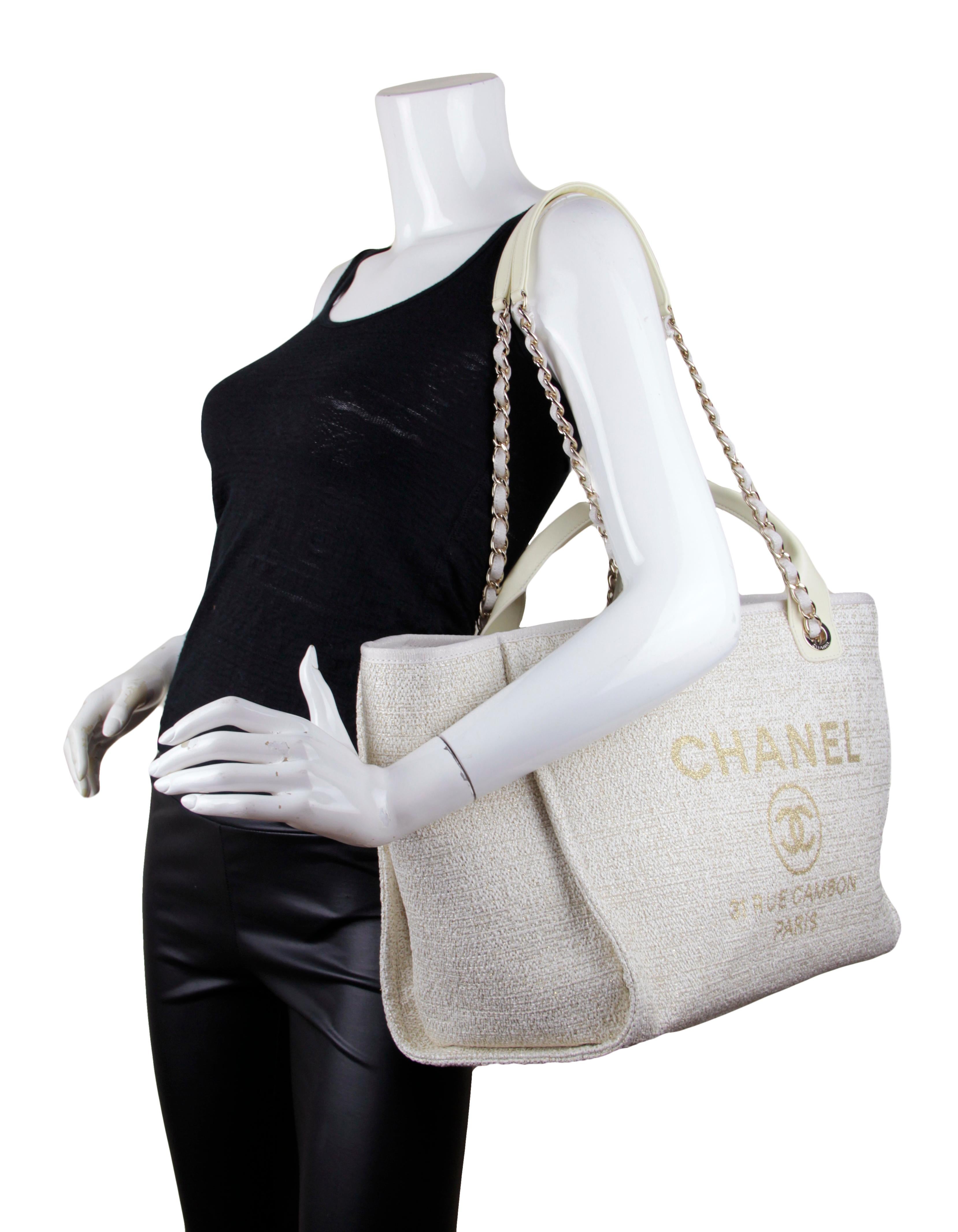 Chanel 2021 Ivory/ Gold Large Deauville Shopping Tote Bag

Made In: Italy
Year of Production: 2021
Color: Ivory and gold
Hardware: Pale goldtone
Materials: Woven canvas, leather
Lining: Beige canvas
Closure/Opening: Open top with center magnetic
