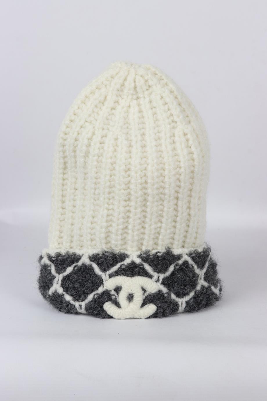 Chanel 2021 logo detailed ribbed cashmere blend beanie. White and grey. 66% Cashmere, 20% alpaca, 8% wool, 3% silk, 3% polyamide. Does not come with dustbag or box. Size: One Size. Height: 11 in. Circumference: 21 in. Very good condition - Worn
