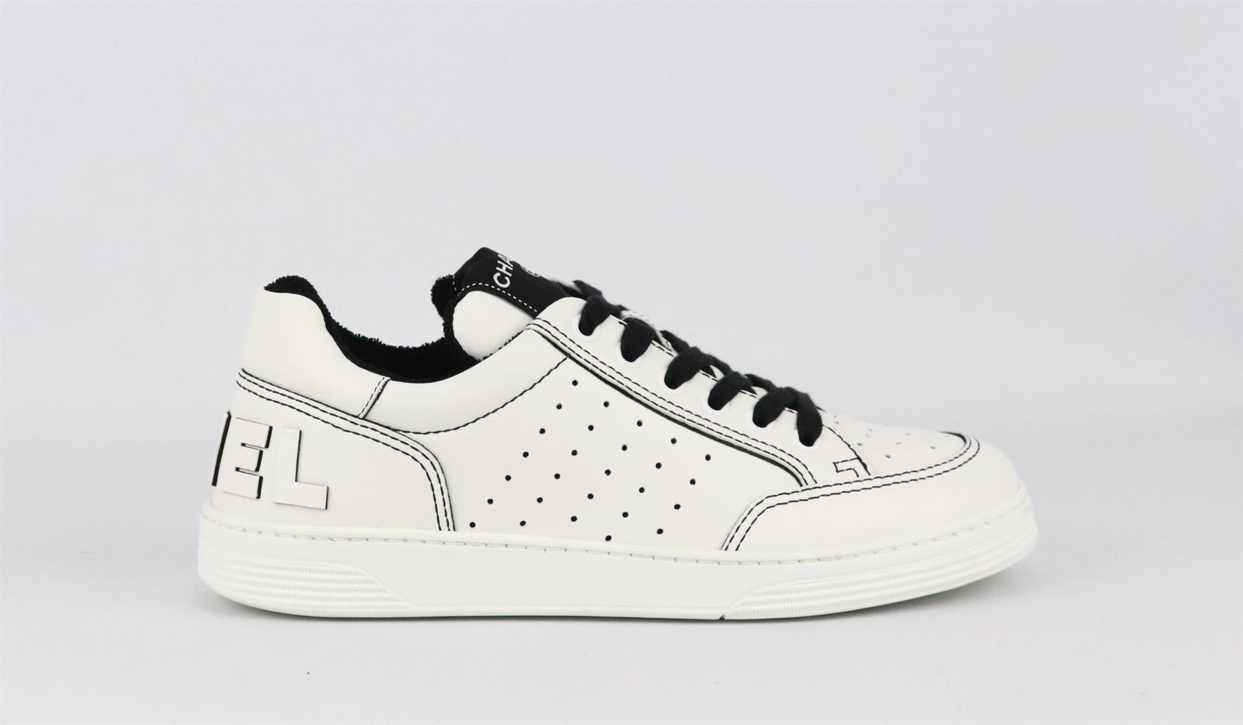Part of Chanel's 2021 Collection, these low-top sneakers have been made from durable calfskin leather, they have the brand's logo on the back in leather and finished with contrast stitching and thick black laces and terry-cloth interior to make it