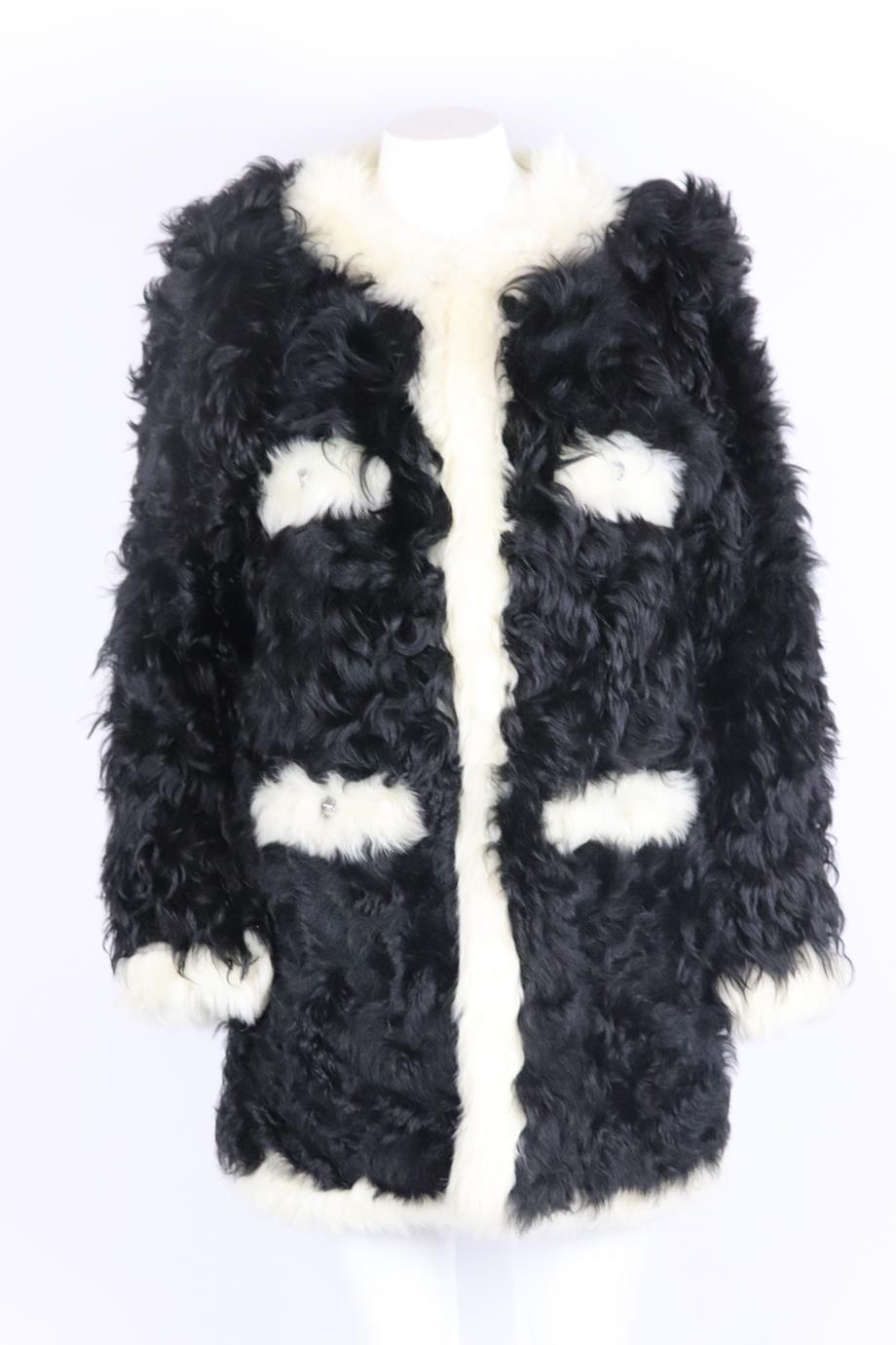 Chanel 2021 two tone shearling coat. Black and cream. Long sleeve, crewneck. Hook and eye fastening at front. 100% Lambskin; lining: 100% silk. Size: FR 46 (UK 18, US 14, IT 50). Shoulder to shoulder: 19 in. Bust: 42 in. Waist: 41 in. Hips: 42 in.