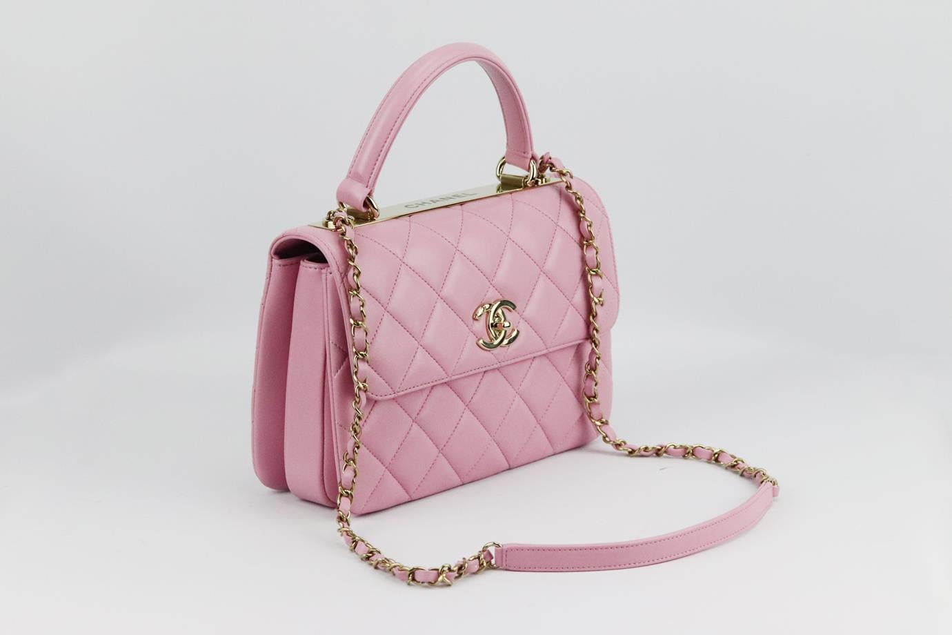 Chanel 2022 Trendy CC small quilted leather shoulder bag. Made from pink quilted leather with CC gold-tone hardware on the front and logo plaque at the top, it has three large internal compartment with slit pocket. Pink. Twist lock at front. Comes