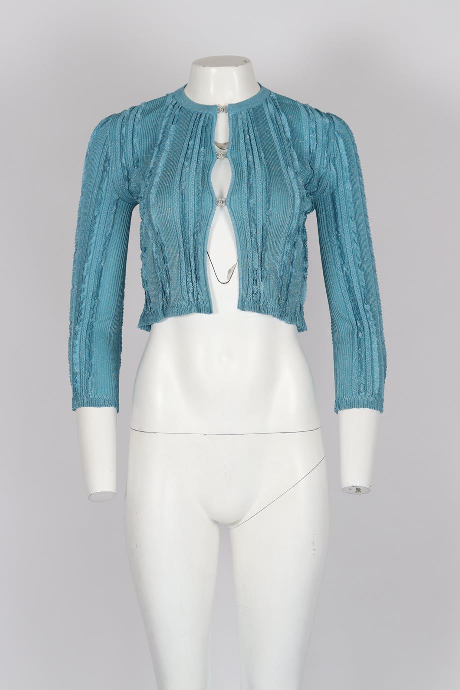 Chanel 2023 Cc Detailed Ribbed Knit Cardigan. Blue. Long Sleeve. Crewneck. Hook and eye fastening - Front. 86% Viscose, 6% metallised fibre, 6% polyamide. 1% metal polyester, 1% polyurethane. FR 34 (UK 6, US 2, IT 38). Bust: 26.5 in. Waist: 23.4 in.